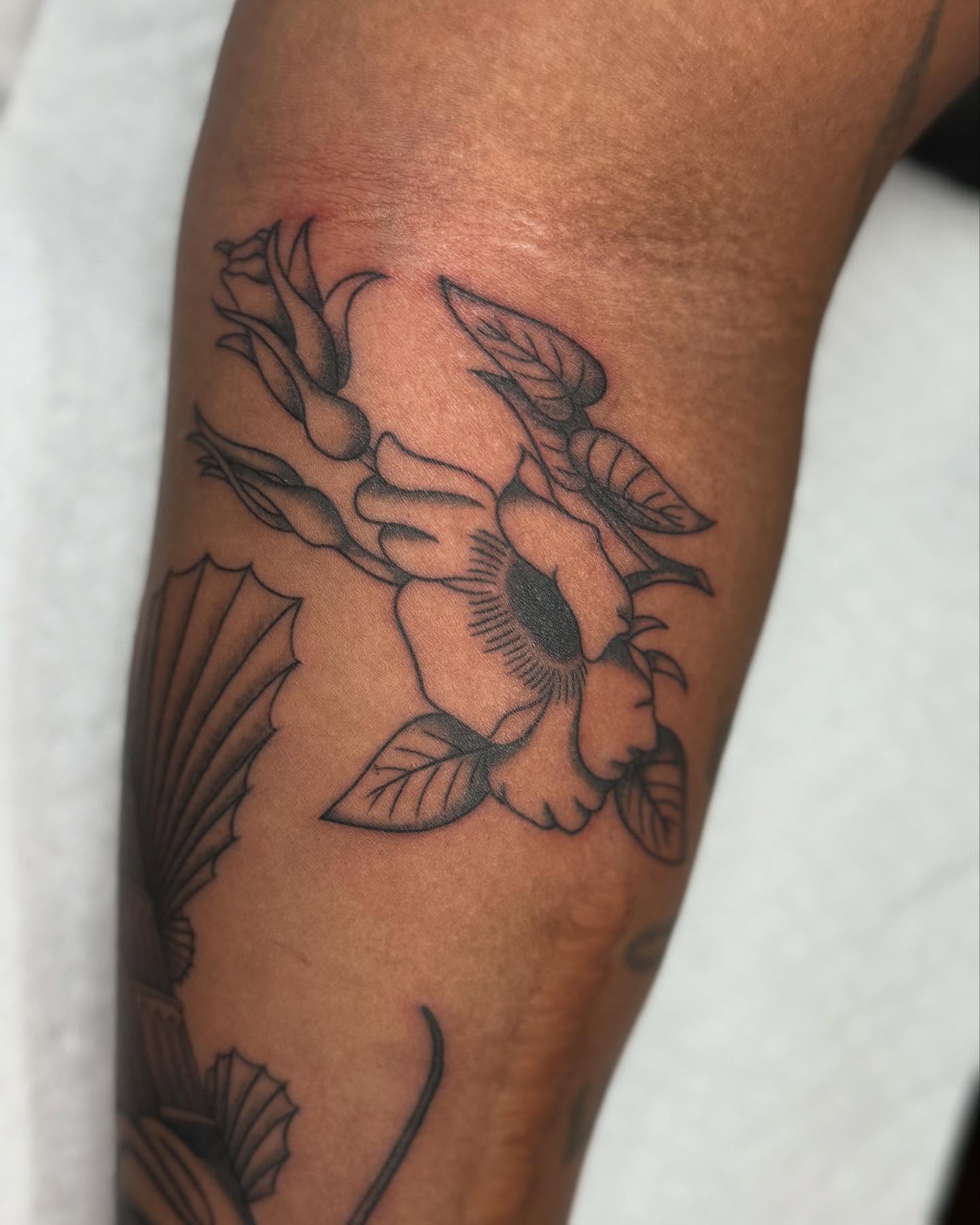 Flower black and grey tattoo on the forearm by Maddie Hammell