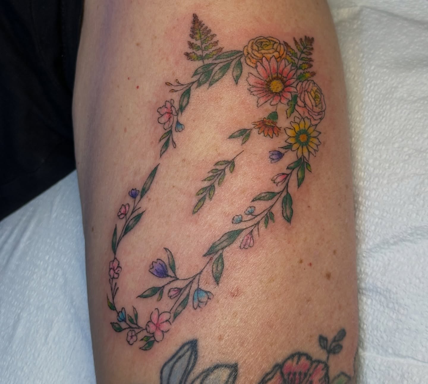 Floral wreath new school tattoo on the forearm by Lauren DeLizza