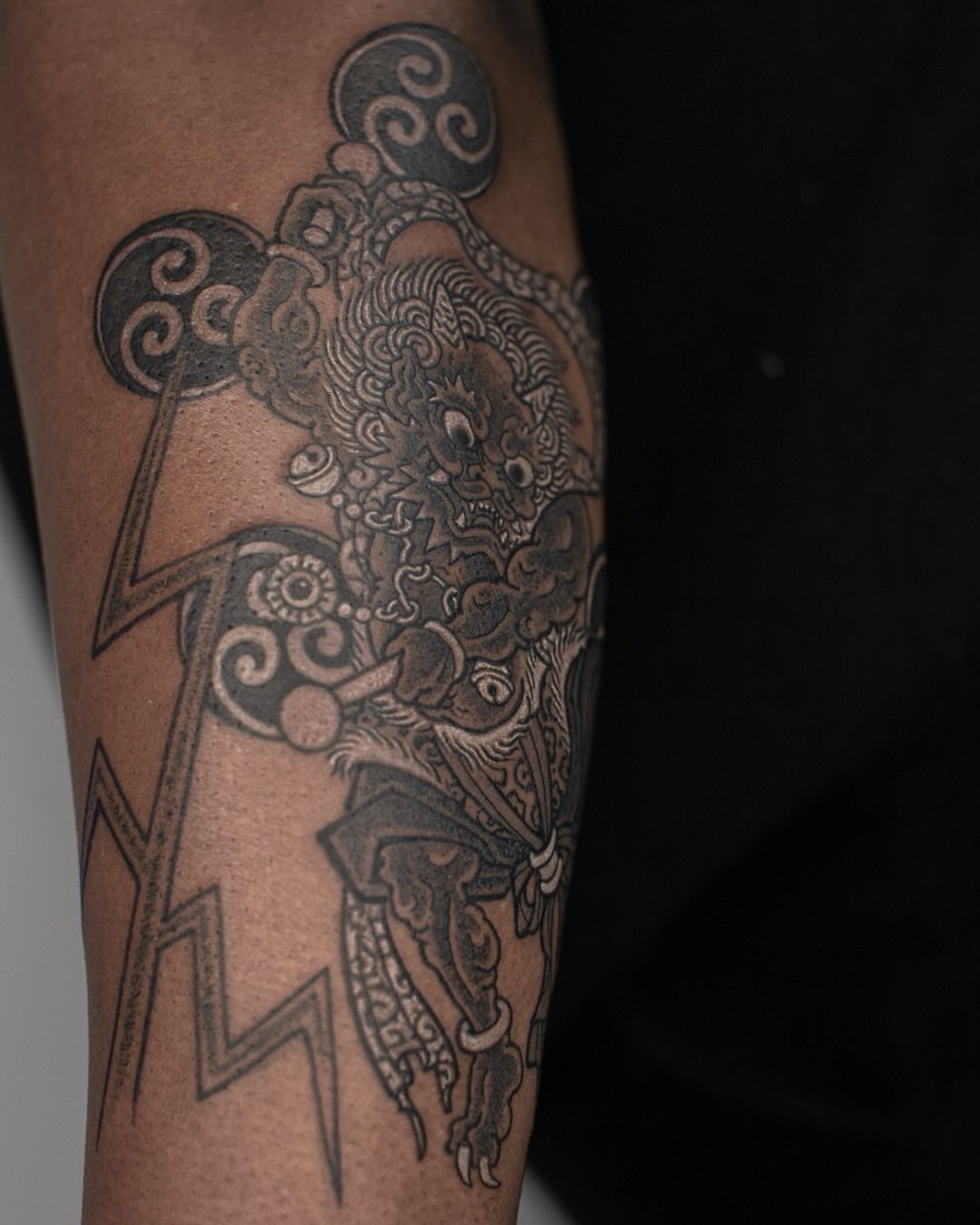 Lion-like creature black and grey tattoo on the forearm by 홍대타투