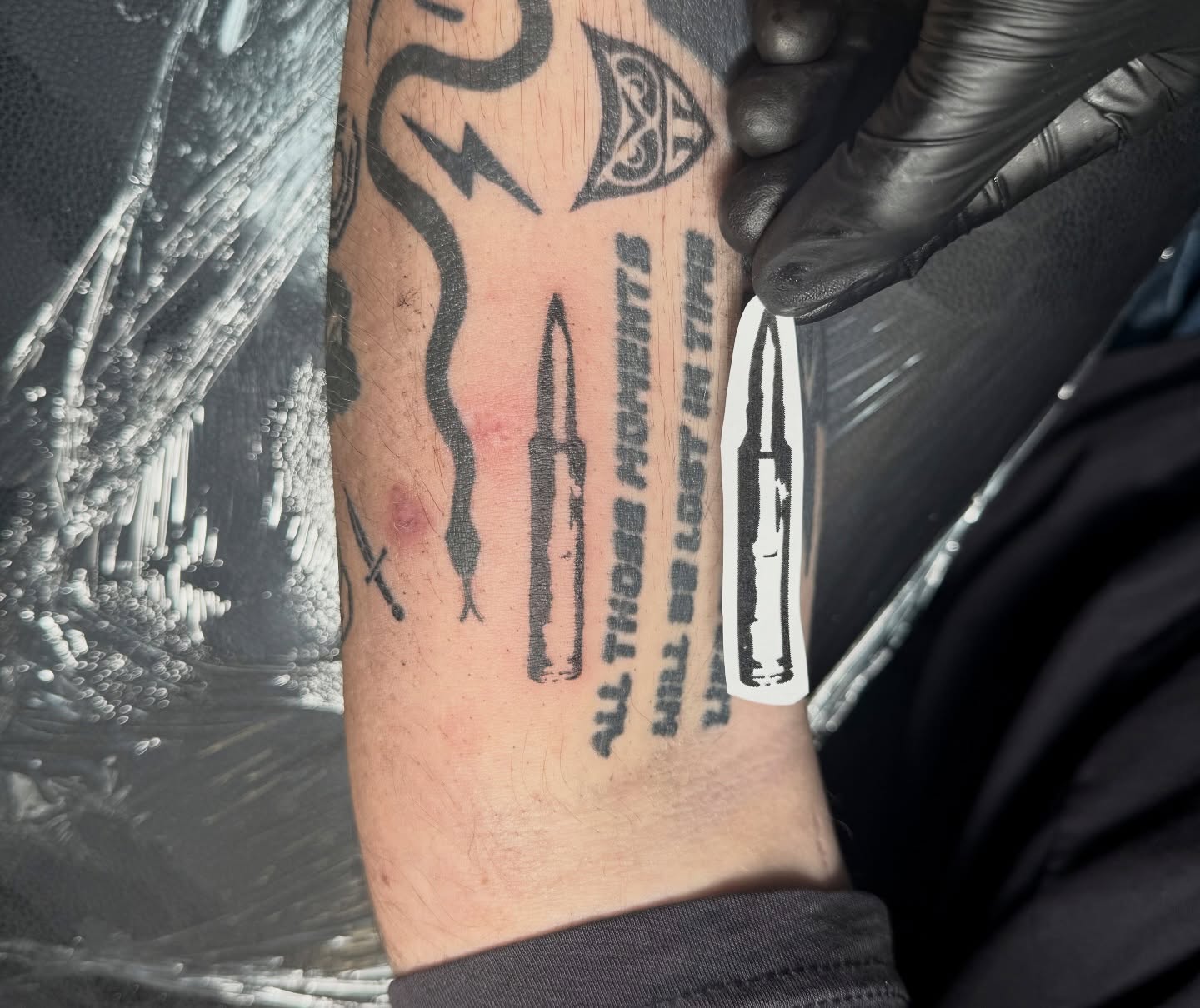 Bullet and quote black and grey tattoo on the forearm by Shay - Mandeville Tattoo Artist