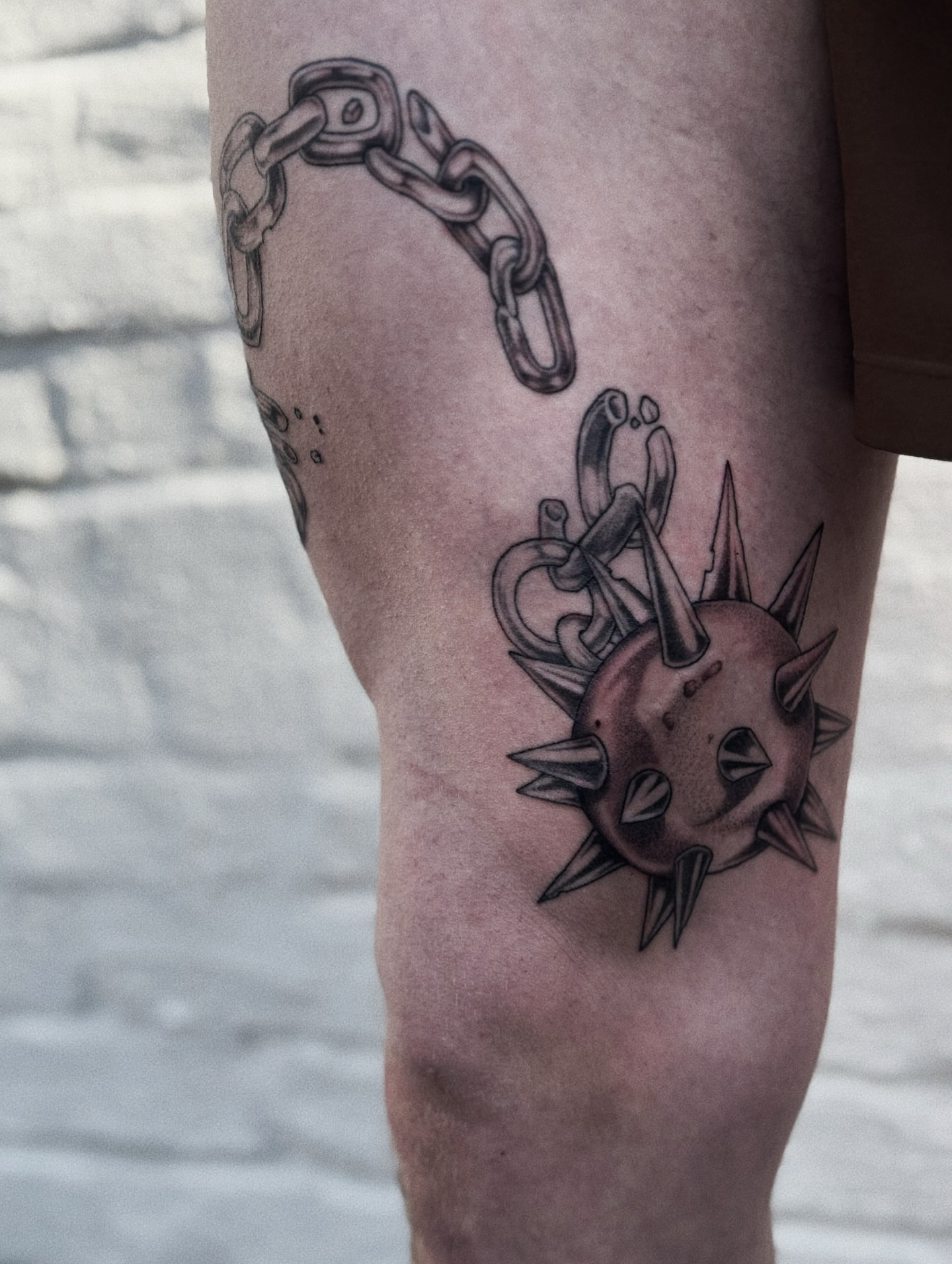 Chain and spiked ball black and grey tattoo on the calf by Virginia 🥀Neo Traditional