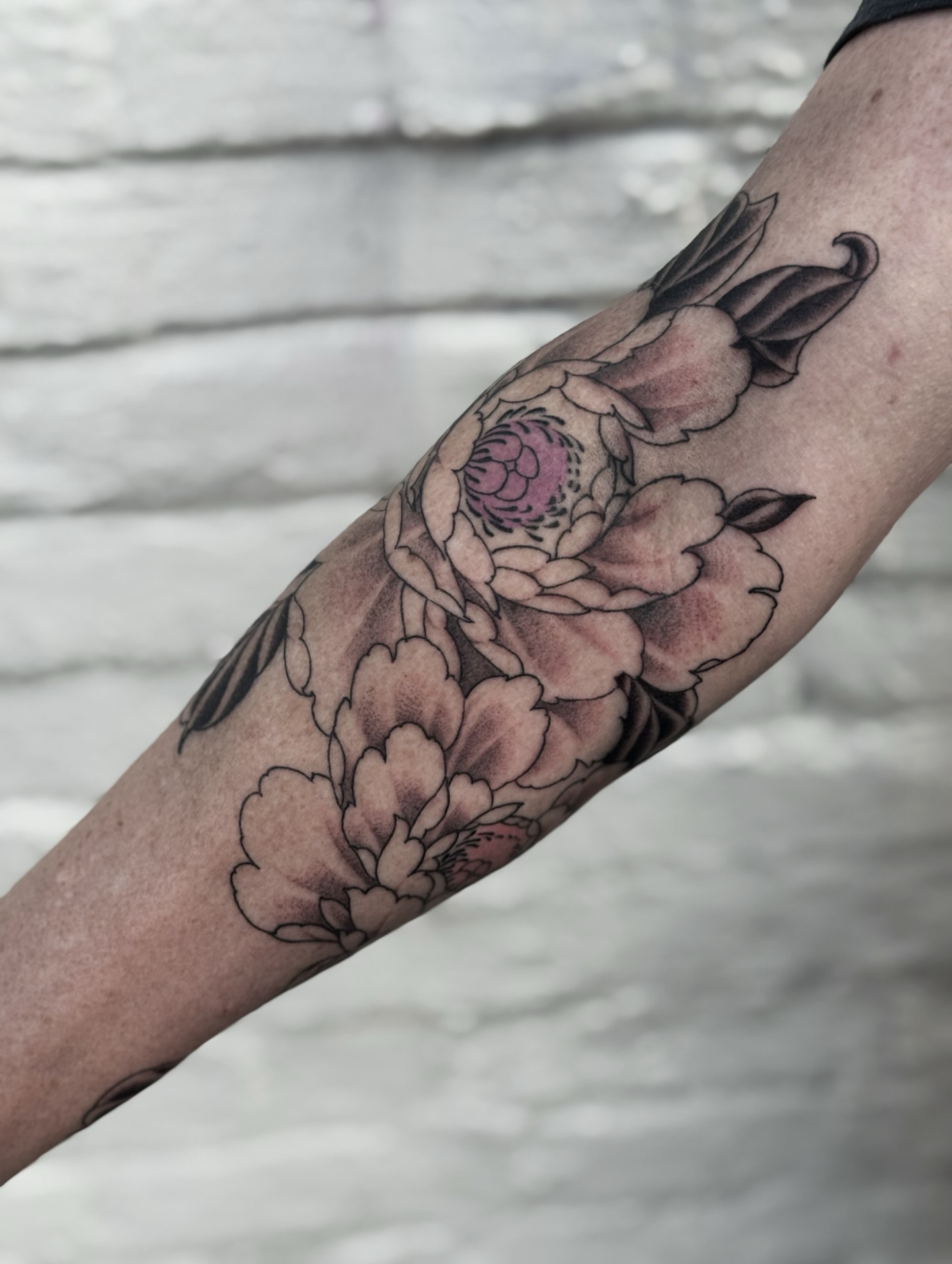 Peony flowers black and grey tattoo on the forearm by Virginia 🥀Neo Traditional