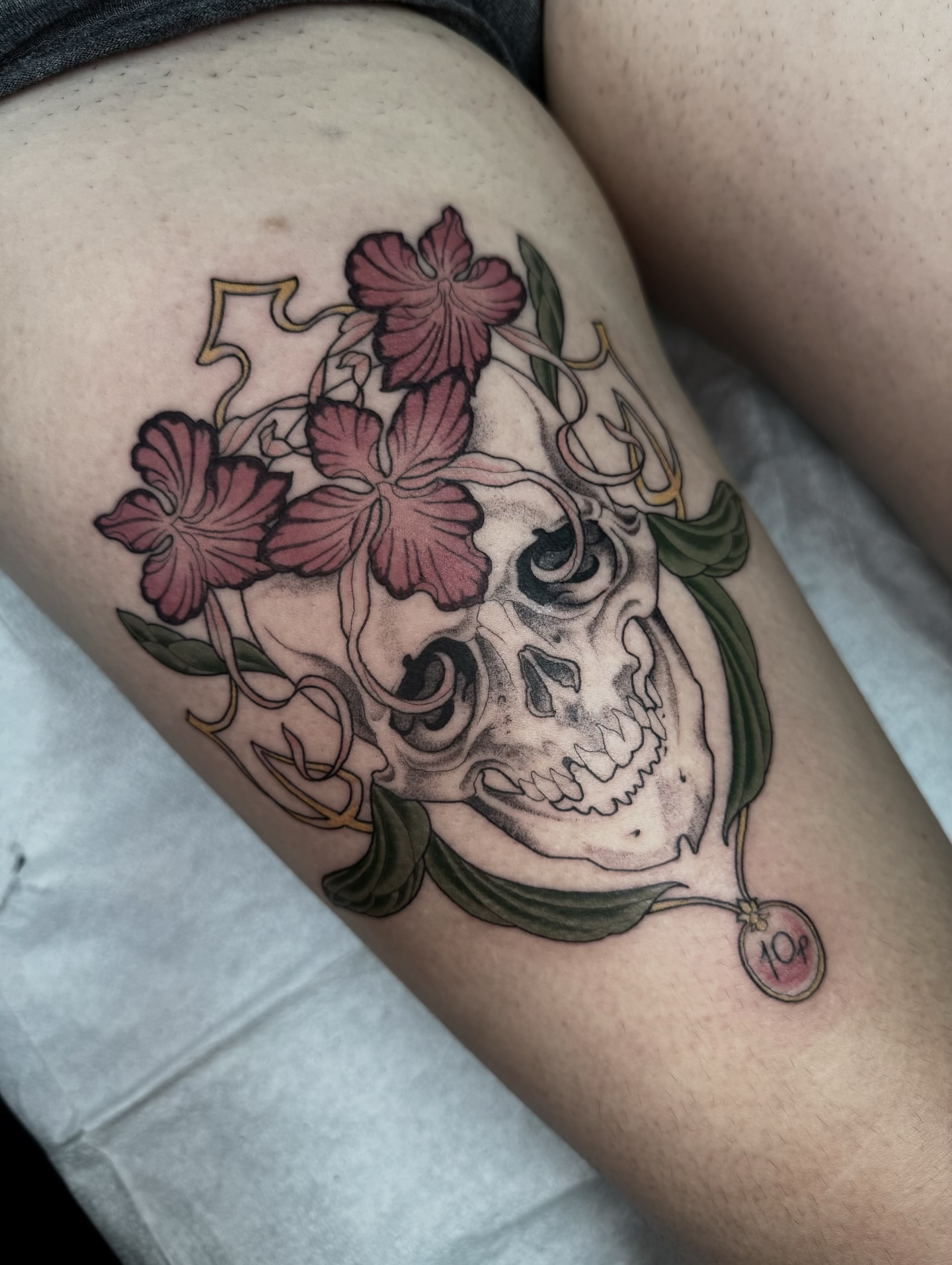 Skull with flowers realism tattoo on the thigh by Virginia 🥀Neo Traditional