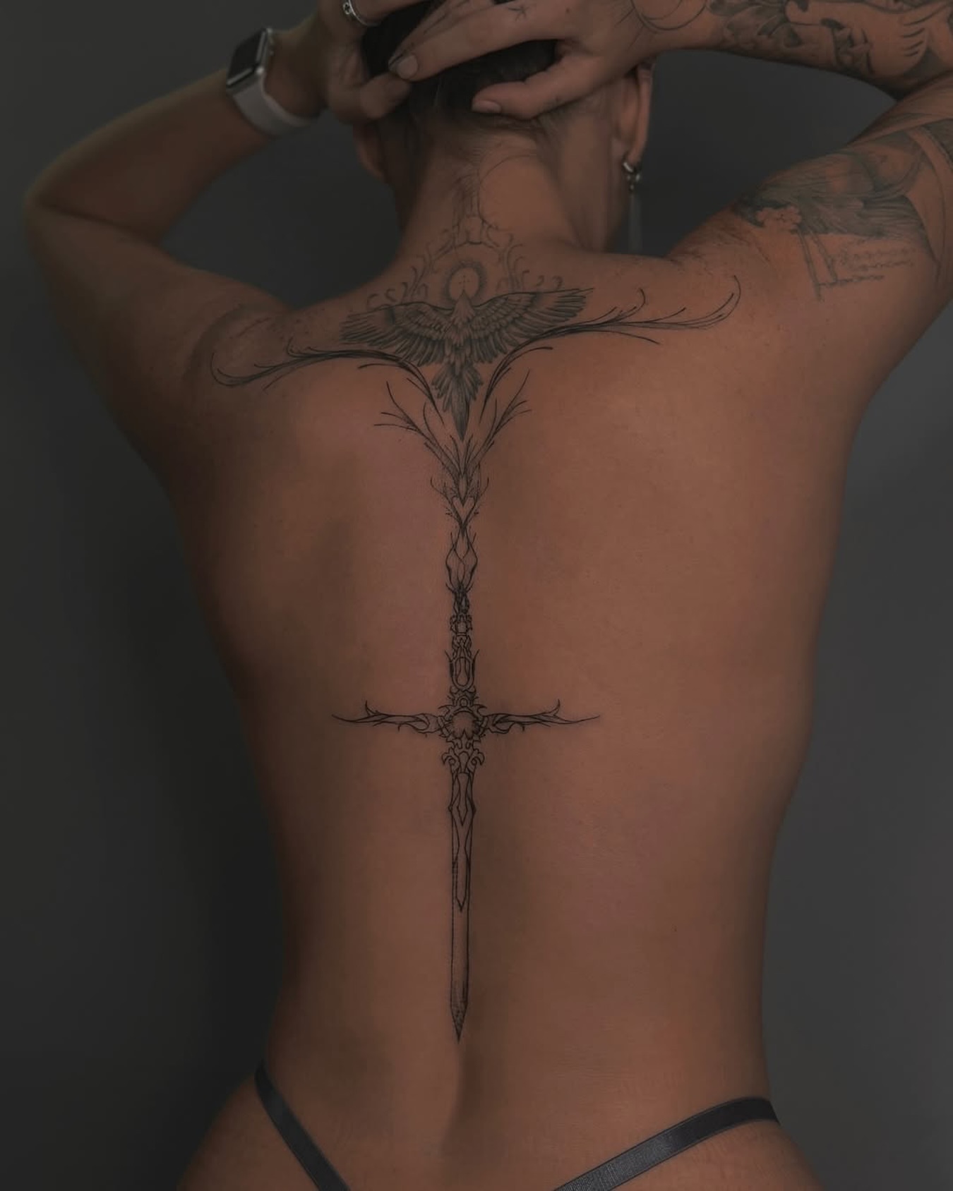 Sword black and grey tattoo on the back by Nina Fedorchenko