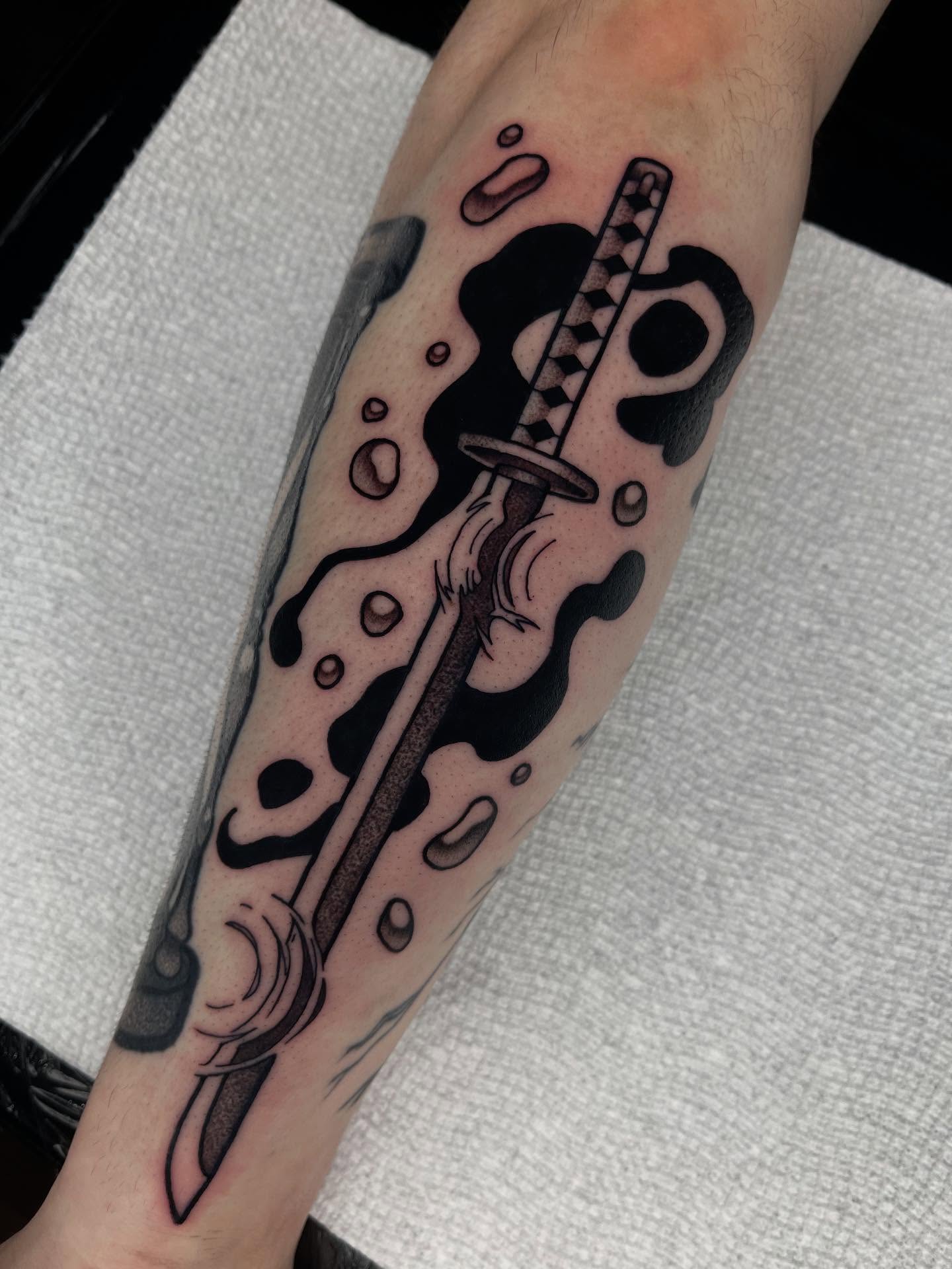 Katana sword black and grey tattoo on the forearm by Anastasia Vives
