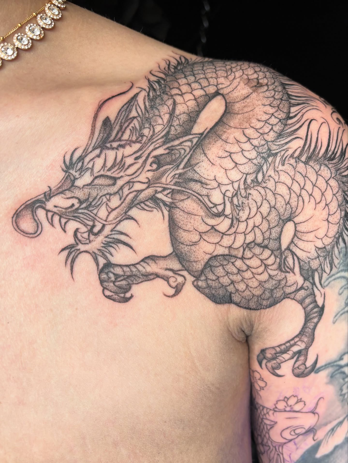 Dragon black and grey tattoo on the shoulder by Ivanna
