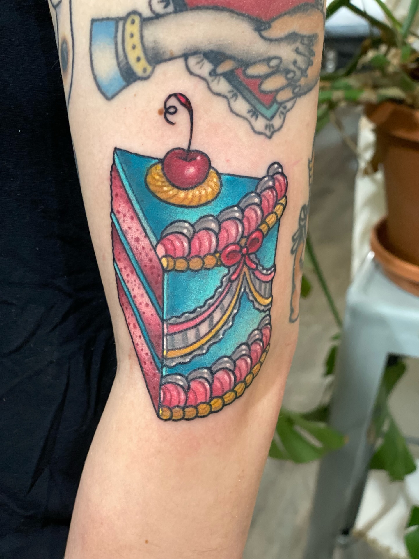 Cherry pie slice American traditional tattoo on the forearm by Stacey Martin Smith