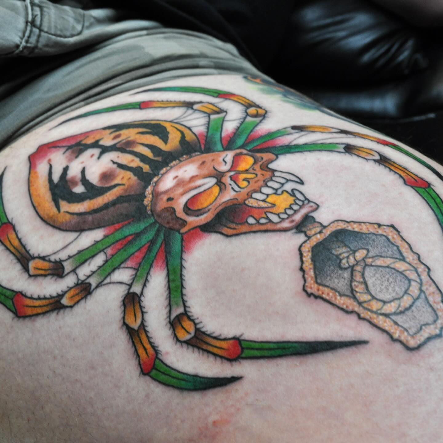 Skull and crab American traditional tattoo on the thigh by Josh Brownell