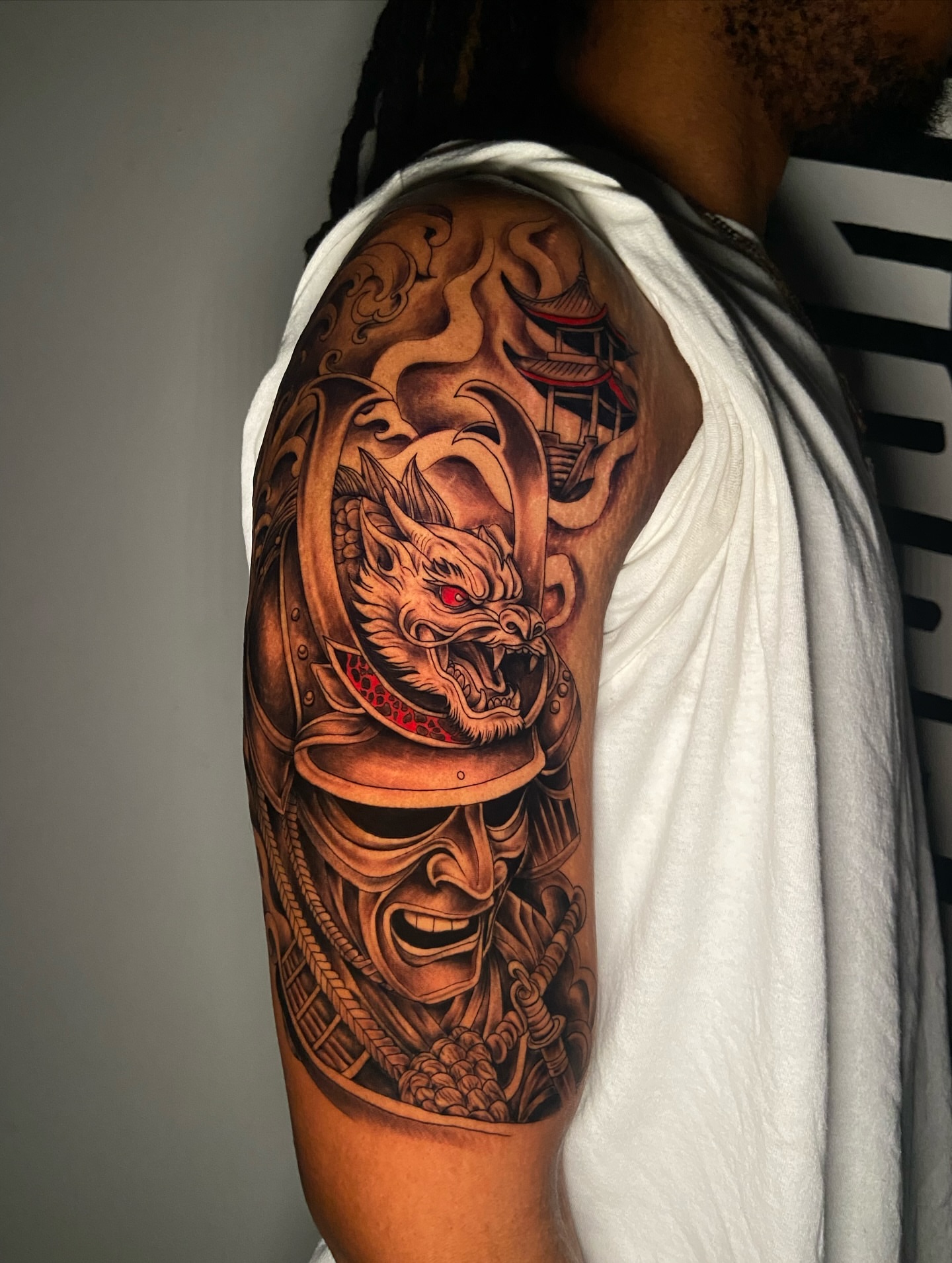 Dragon and samurai helmet japanese irezumi tattoo on the upper arm by Chicago Tattoo Artist