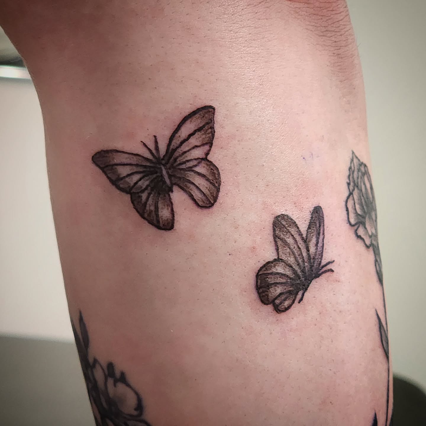 Butterflies black and grey tattoo on the forearm by Anntonietta Borzacchiello