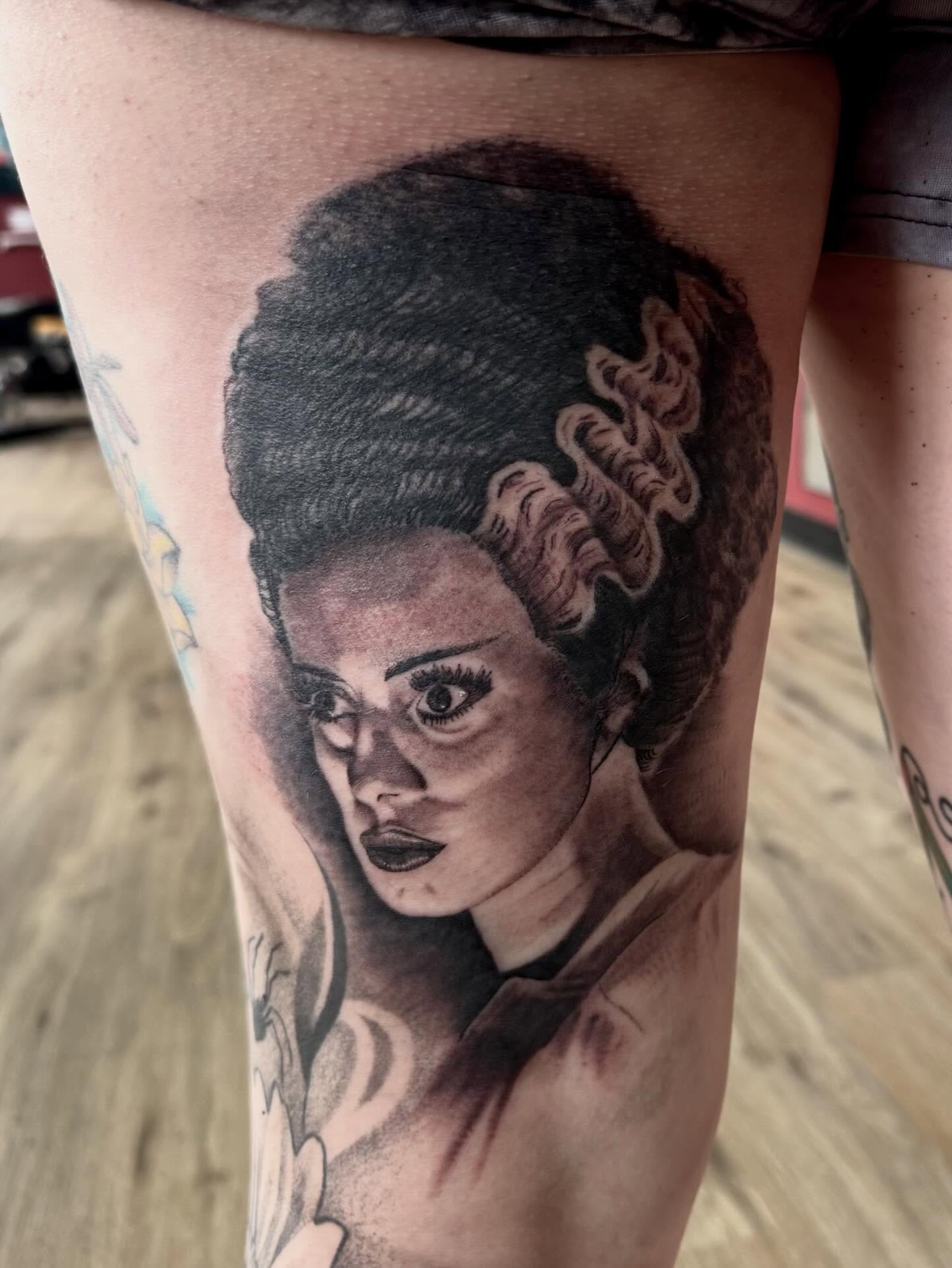 Woman with afro realism tattoo on the thigh by Robbie Bryant