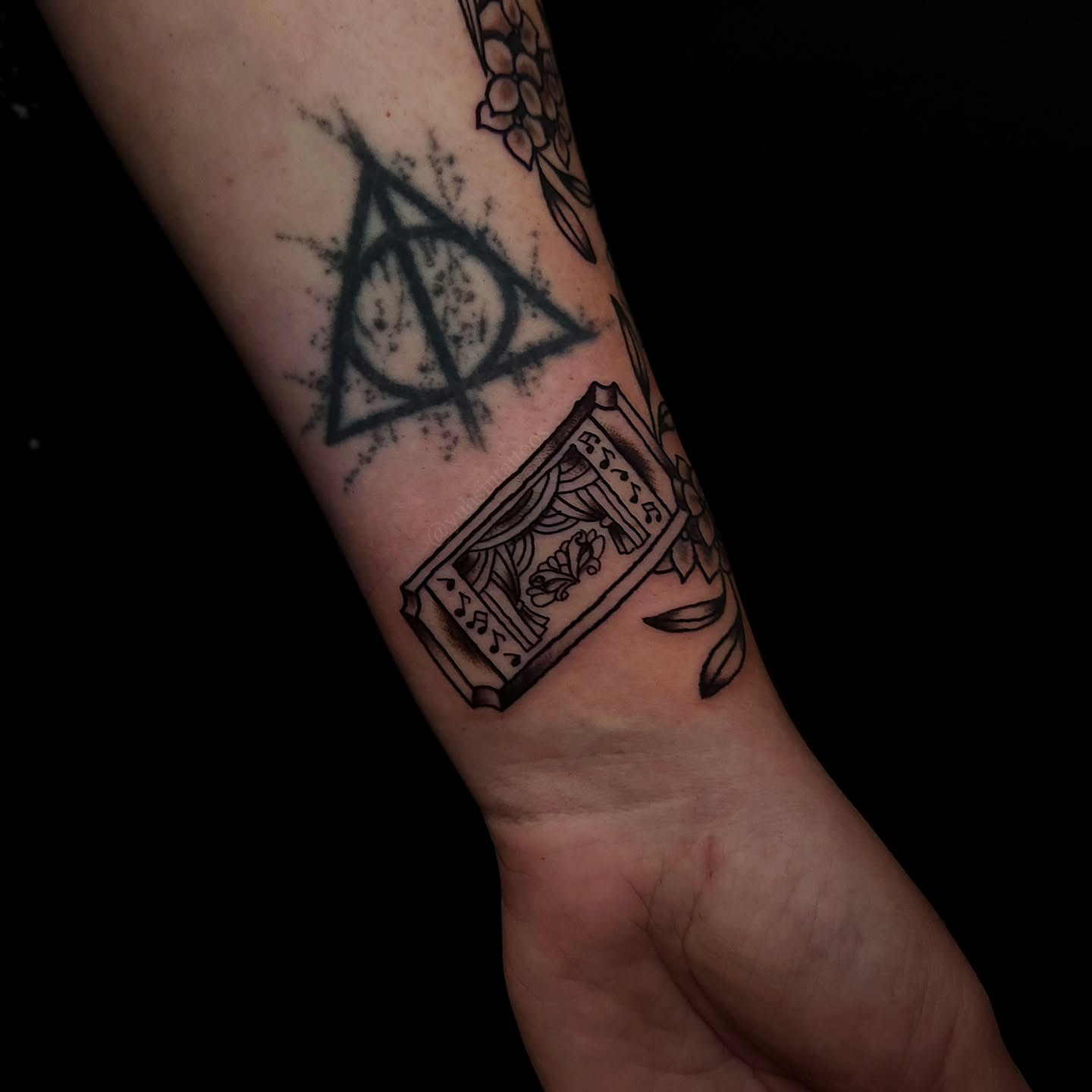 Deathly hallows black and grey tattoo on the forearm by Sheena Yu-Hsin Wood