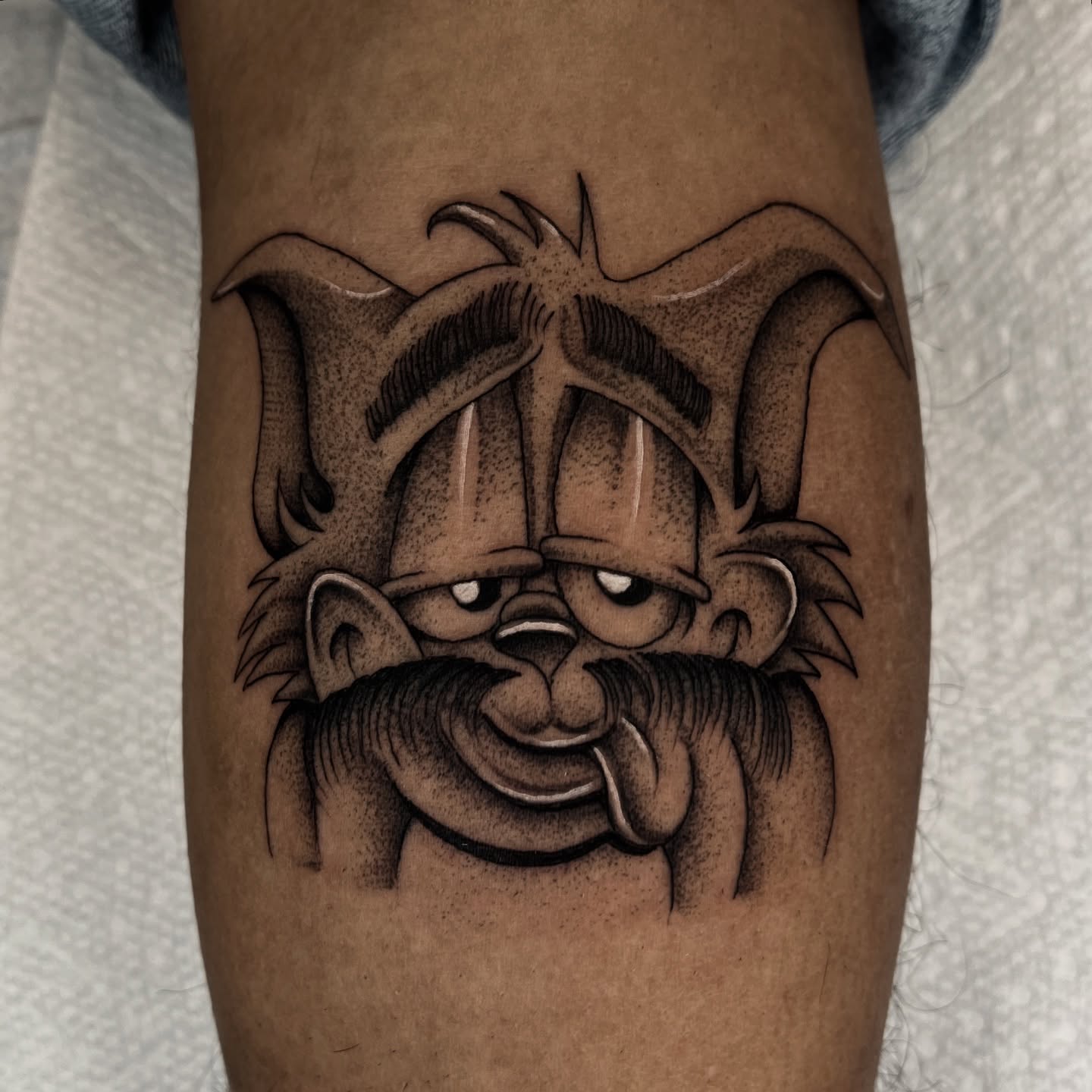 Angry cat black and grey tattoo on the forearm by Jesus Pieces