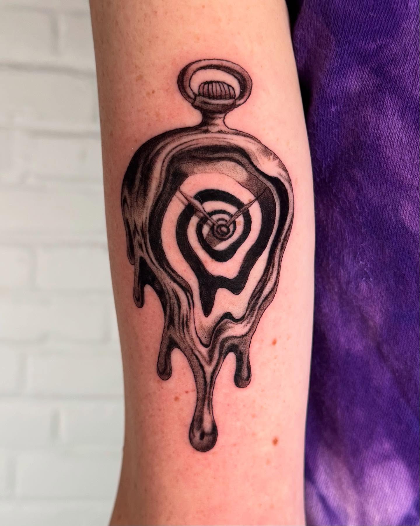 Melting clock surrealism tattoo on the forearm by Erin Blaney