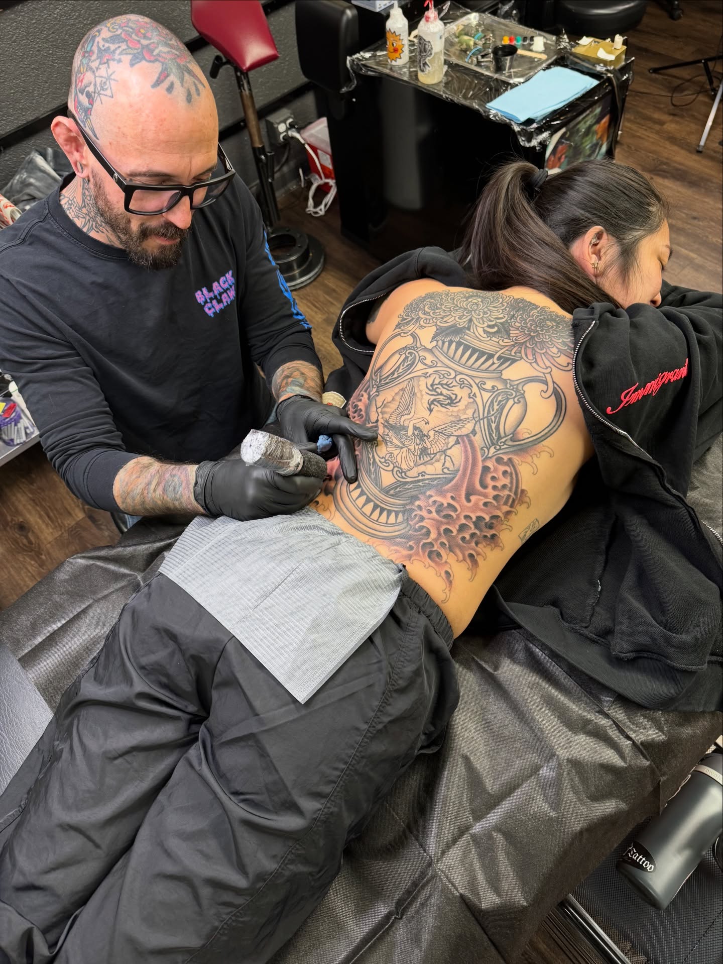 Lion and flames American traditional tattoo on the back by Sarah Pham