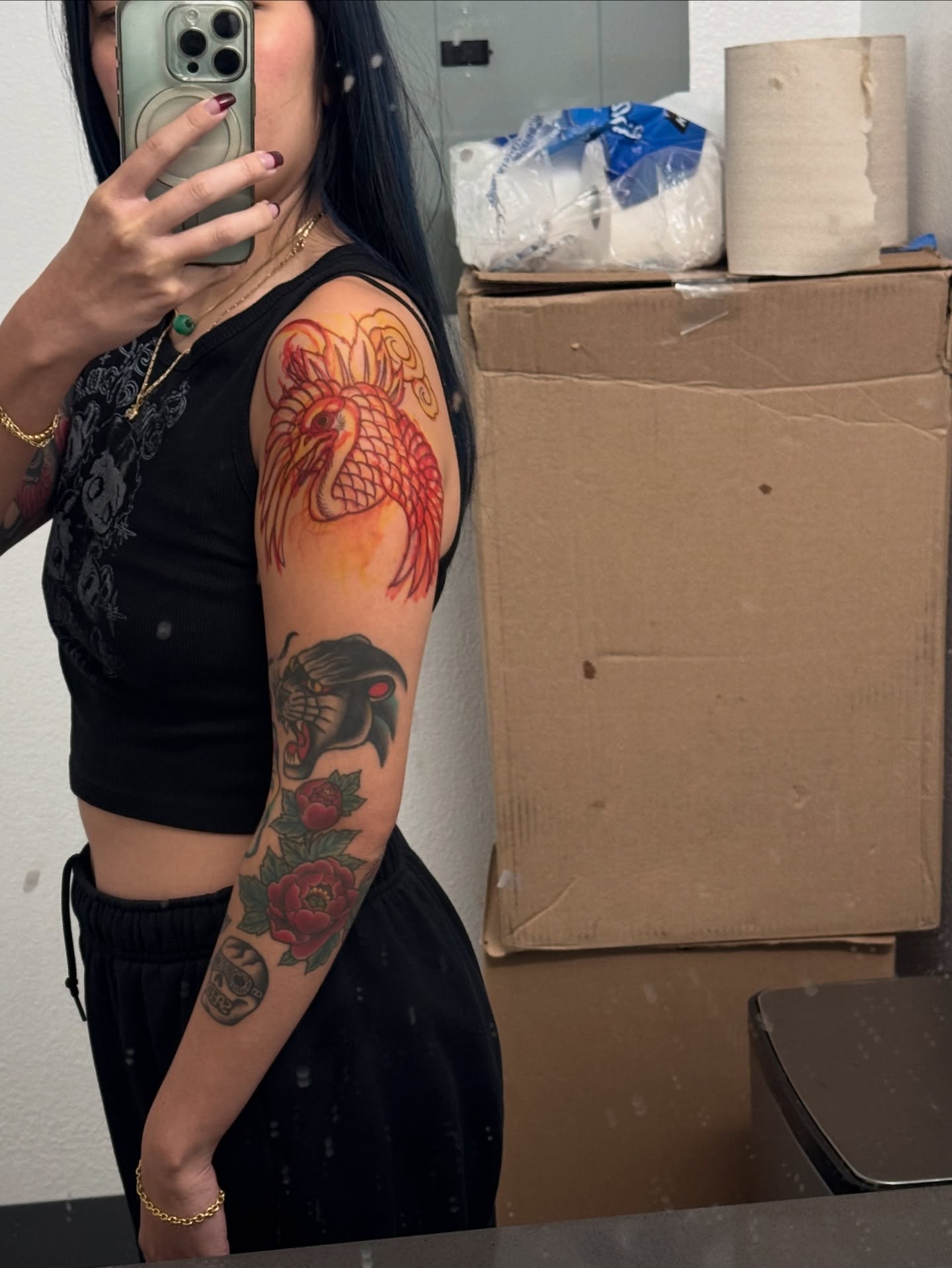 Dragon and peony American traditional tattoo on the upper arm by Sarah Pham