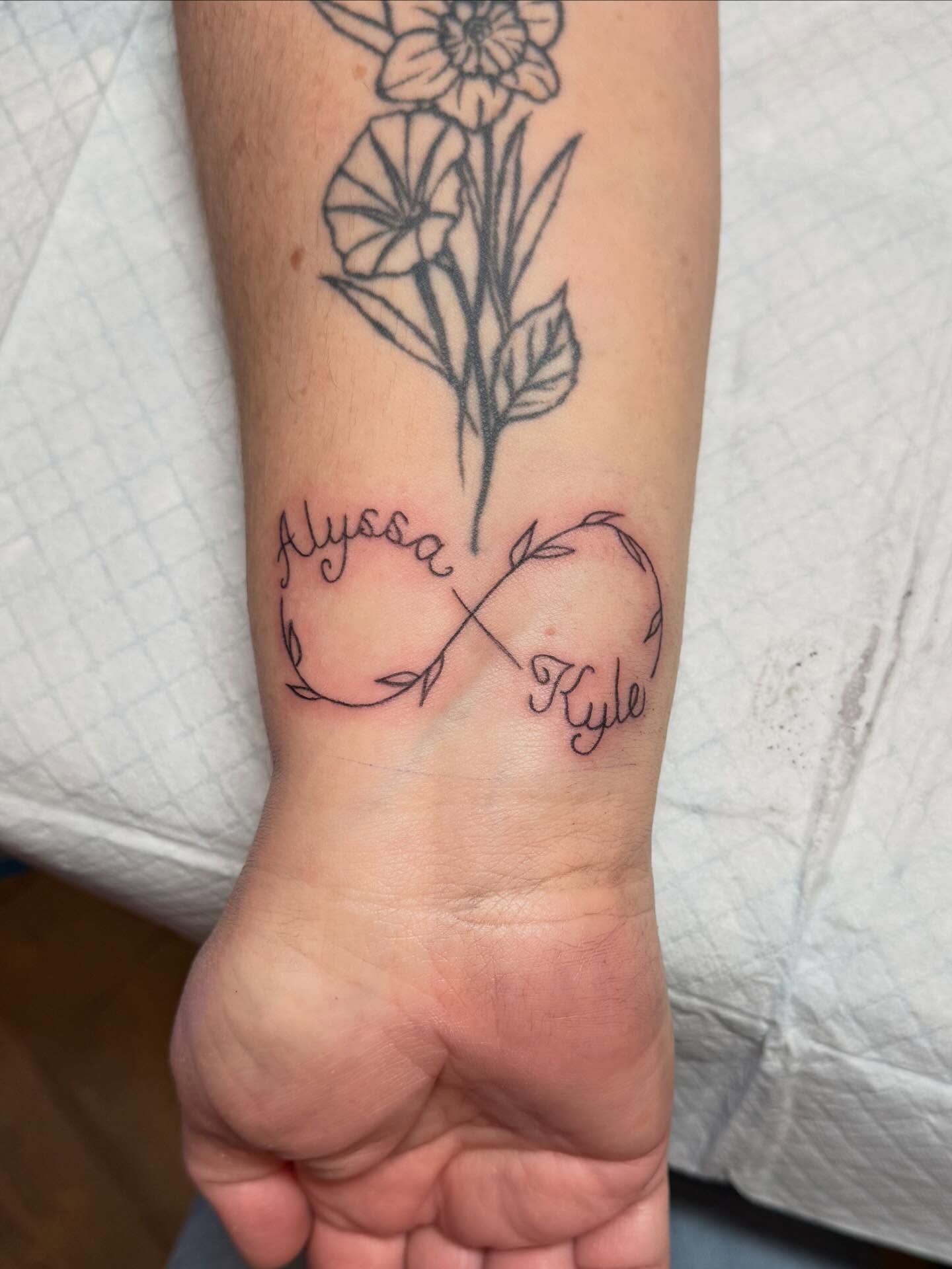 Infinity symbol fine line tattoo on the forearm by zoie rozay hannah