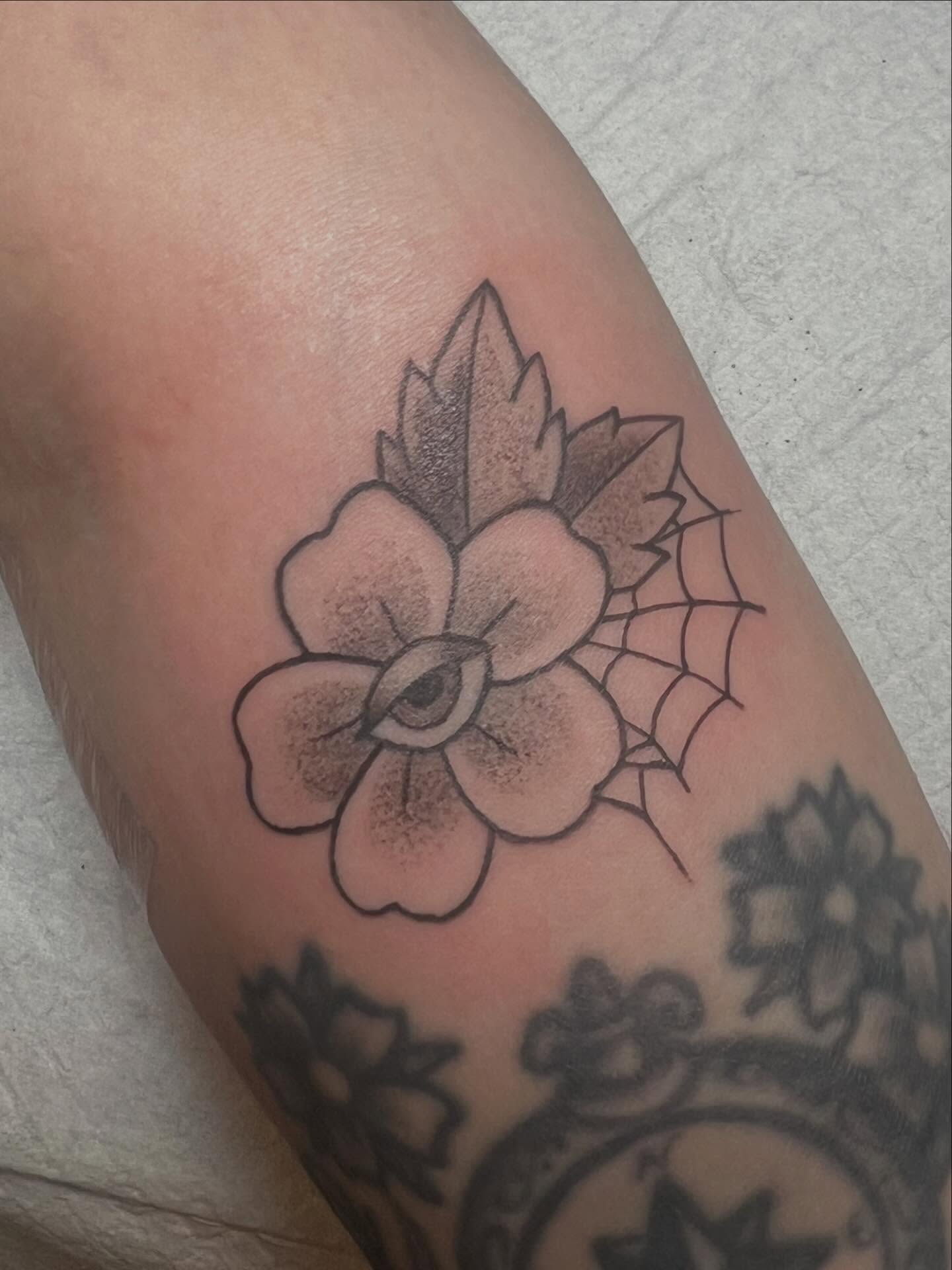 Flower with eye American traditional tattoo on the forearm by zoie rozay hannah