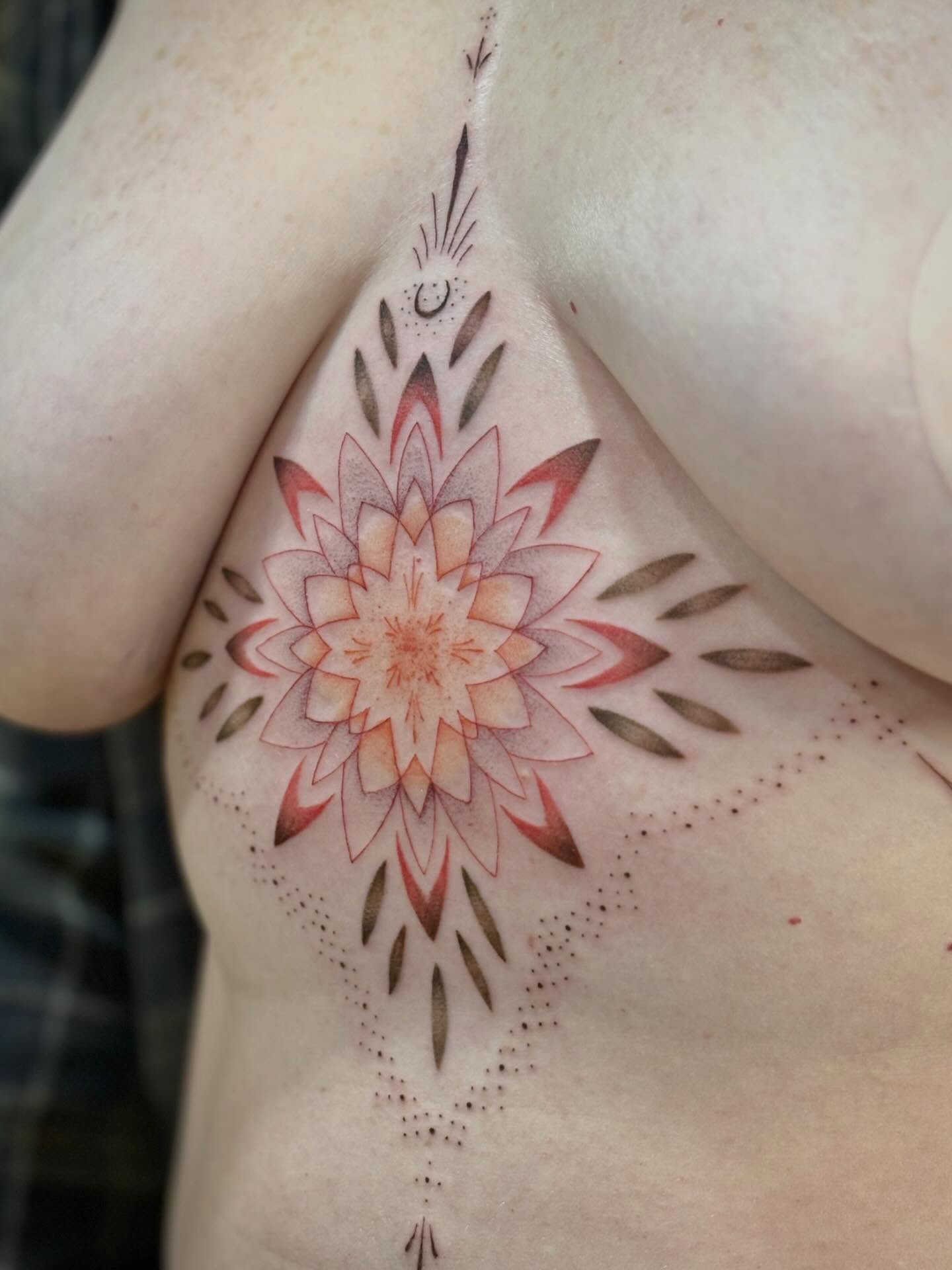 Lotus flower dotwork tattoo on the chest by Jazzlyn Hous