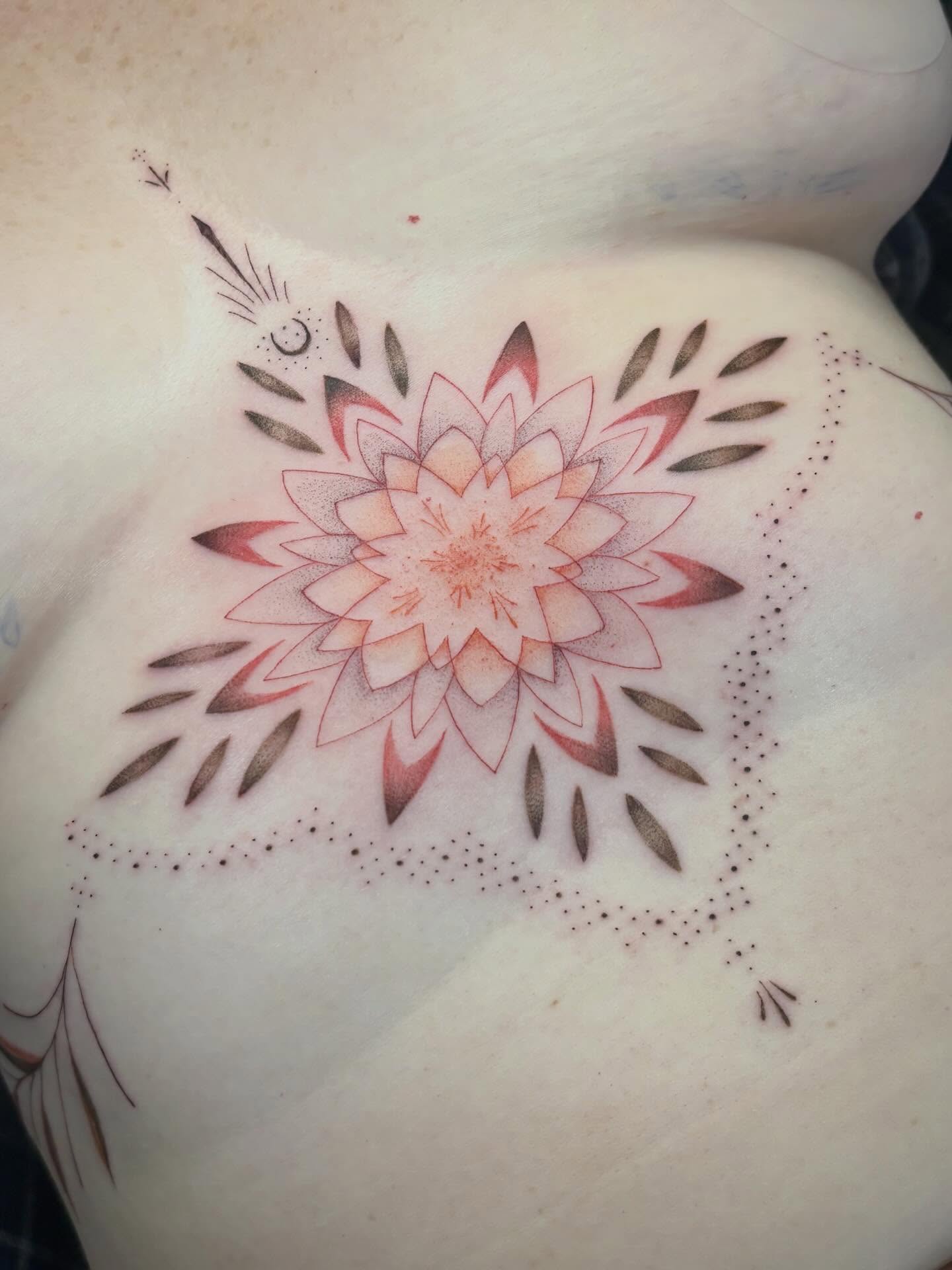 Lotus flower dotwork tattoo on the torso by Jazzlyn Hous