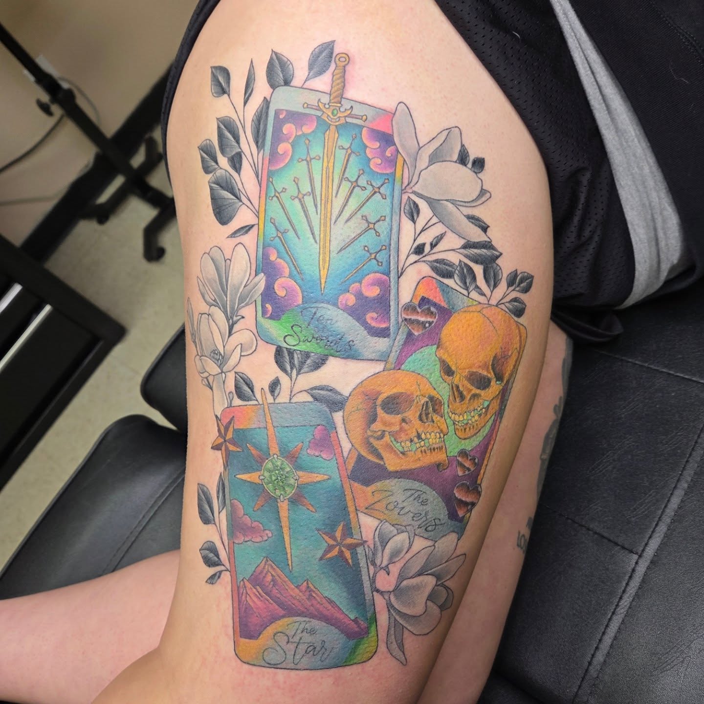 Tarot cards and skulls new school tattoo on the thigh by Ashley
