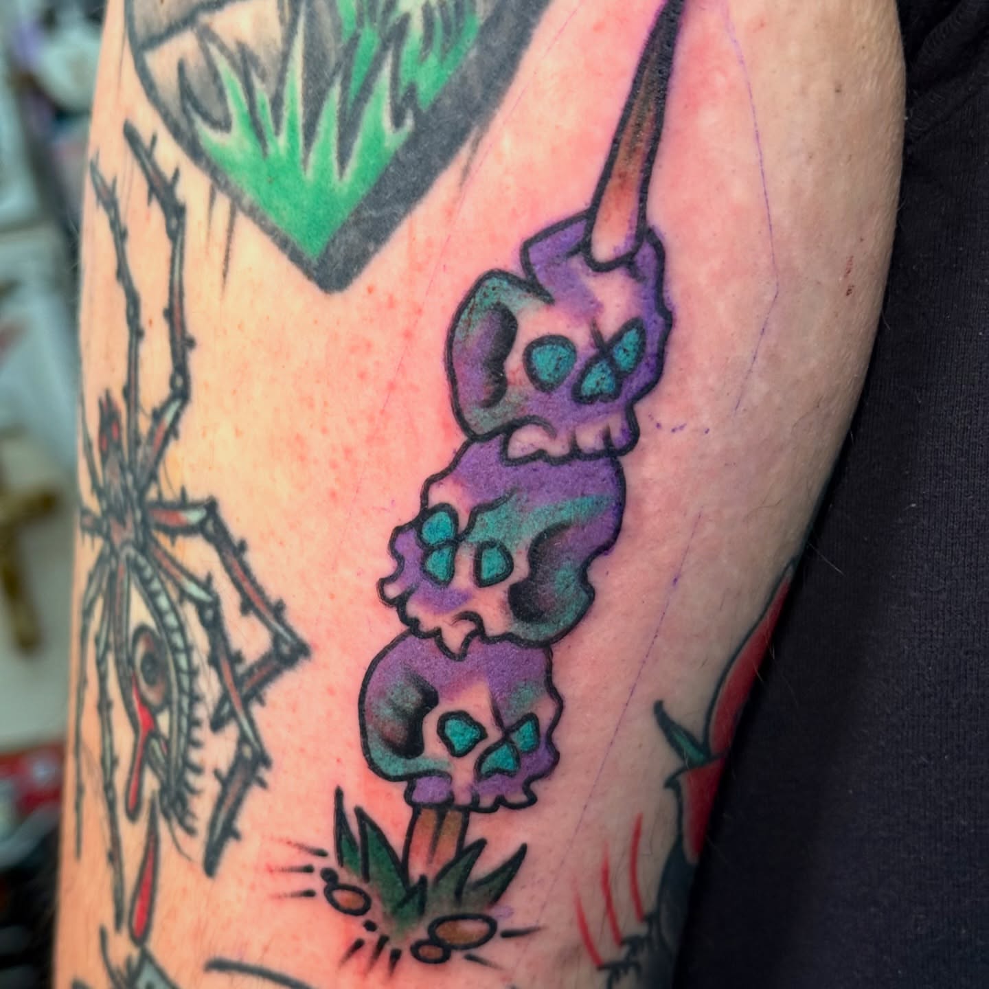 Purple skull American traditional tattoo on the forearm by sydtatz