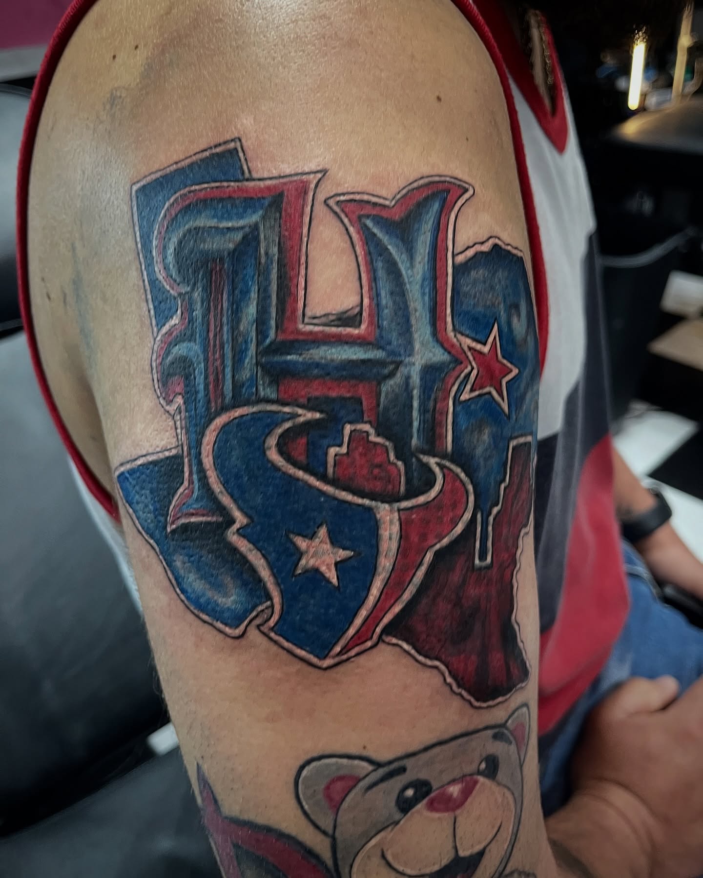 Houston texans logo American traditional tattoo on the upper arm by Christa Martinez