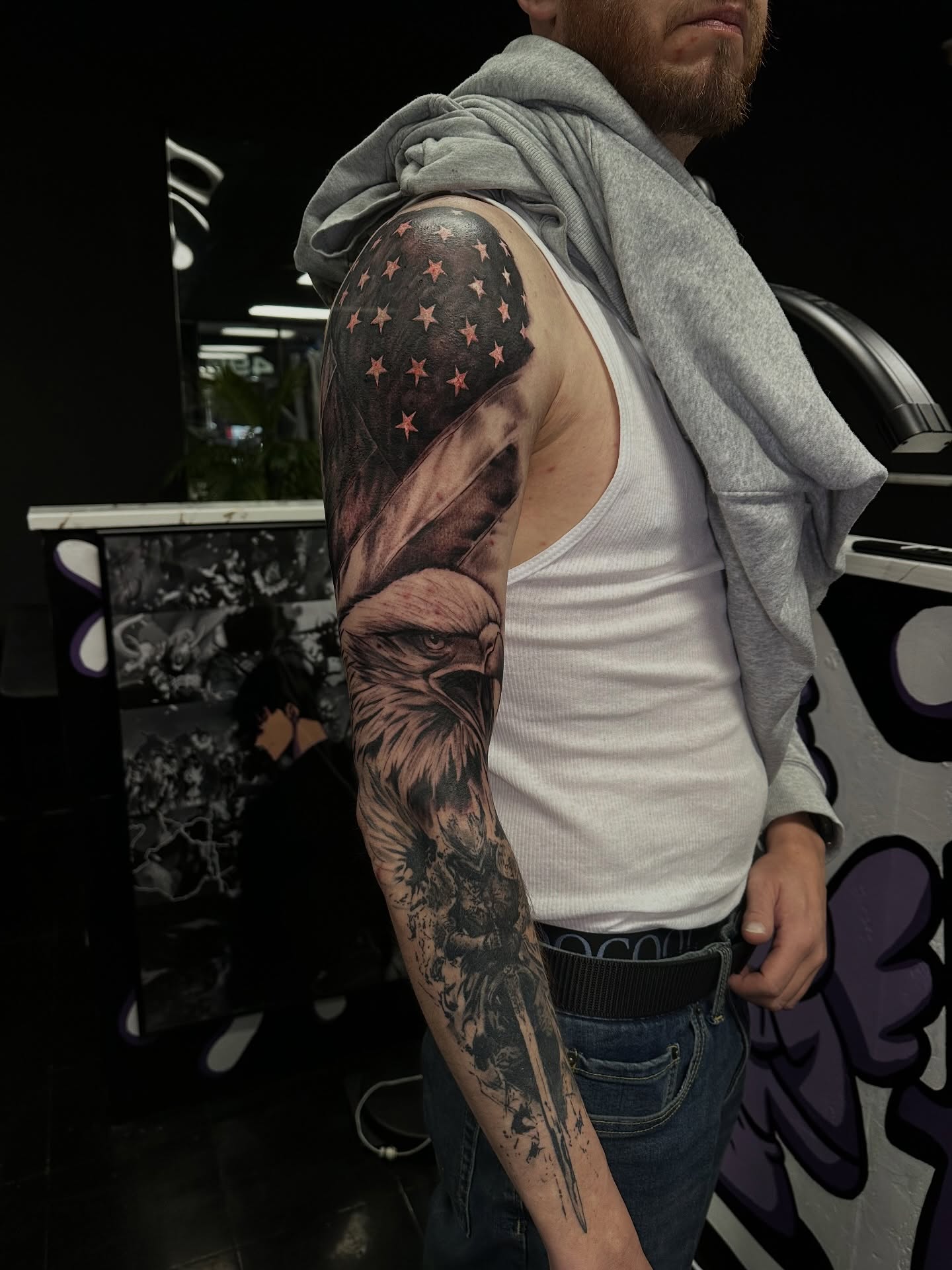 American flag eagle realism tattoo on the upper arm by Angel Tattoos