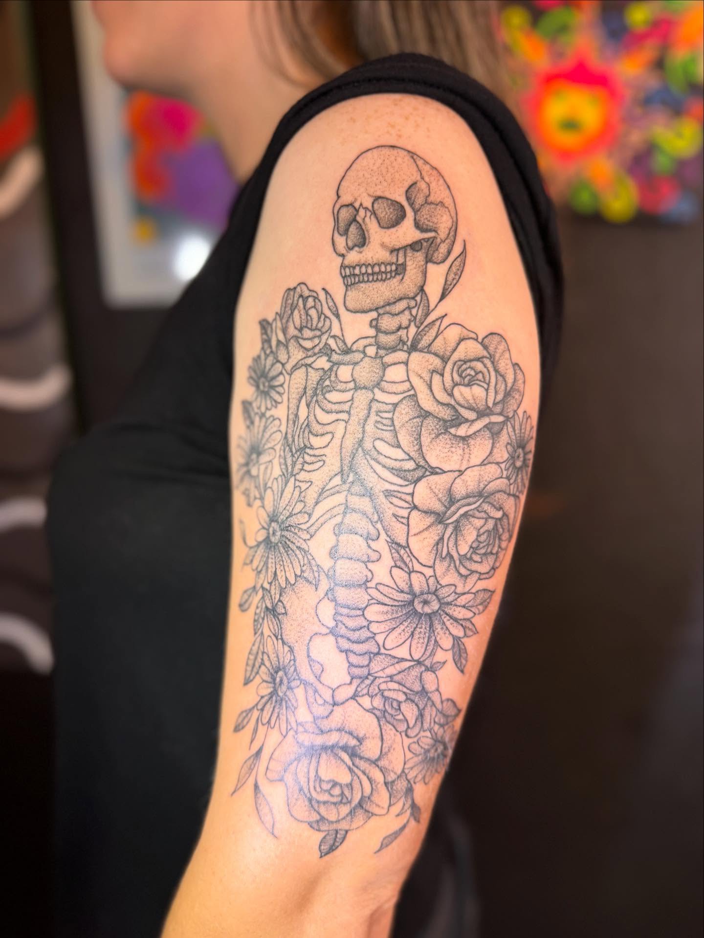 Skeleton with roses black and grey tattoo on the upper arm by Gabs Borderline Tattoos βπΌ