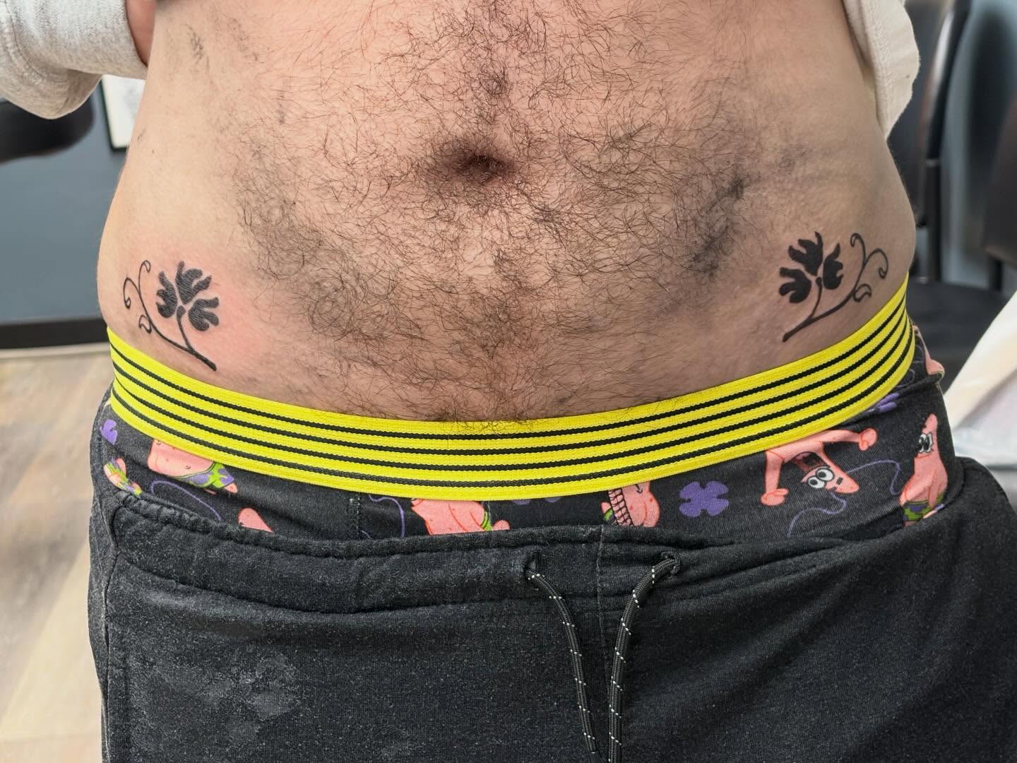 Flower black and grey tattoo on the torso by Madison