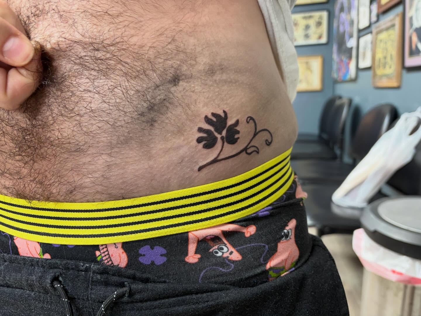 Flower and vine black and grey tattoo on the torso by Madison