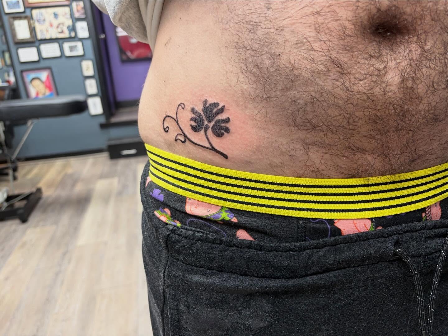Flower black and grey tattoo on the torso by Madison