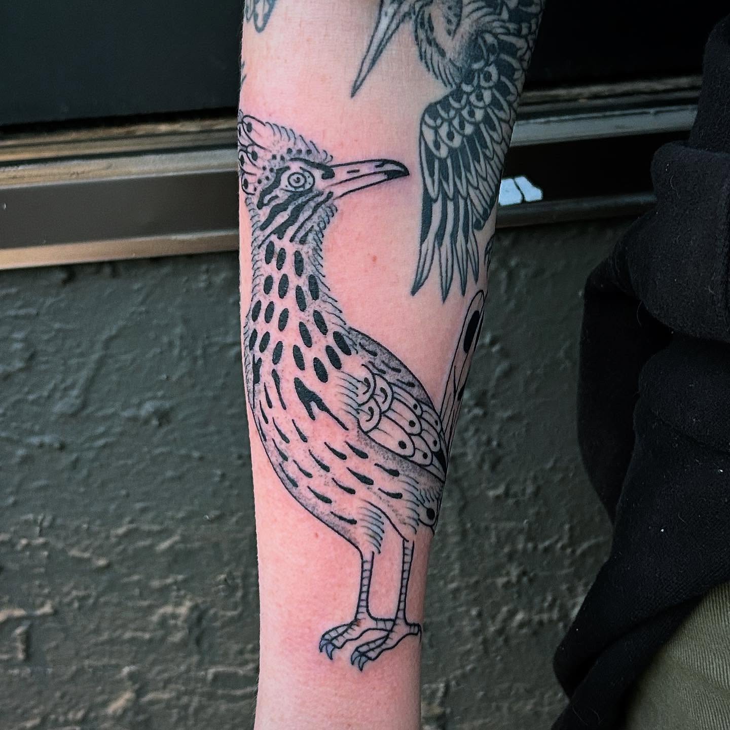 Roadrunner black and grey tattoo on the forearm by Erica Finley