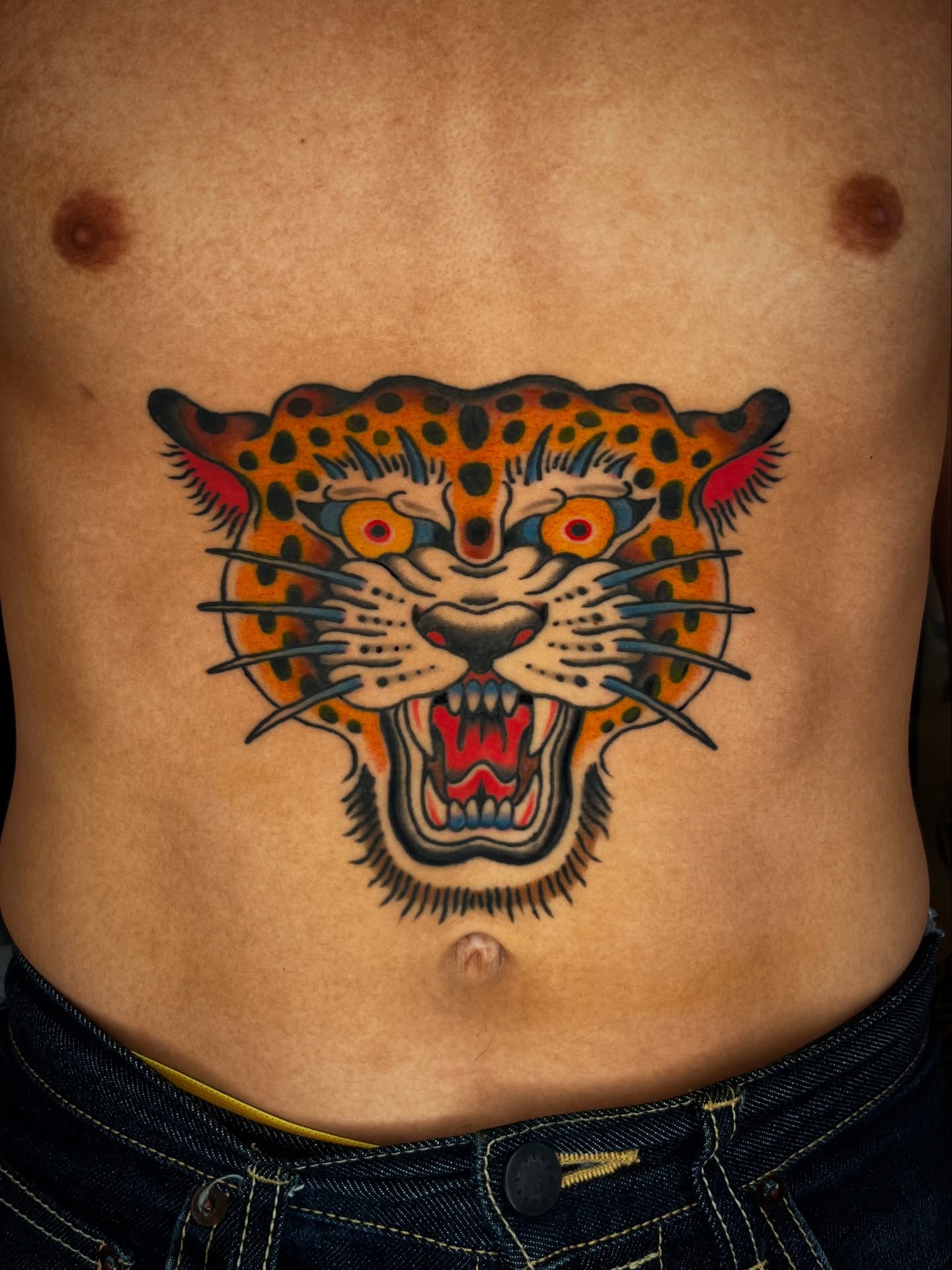 Leopard American traditional tattoo on the torso by Kehrmie Tattoos, Berkeley, California