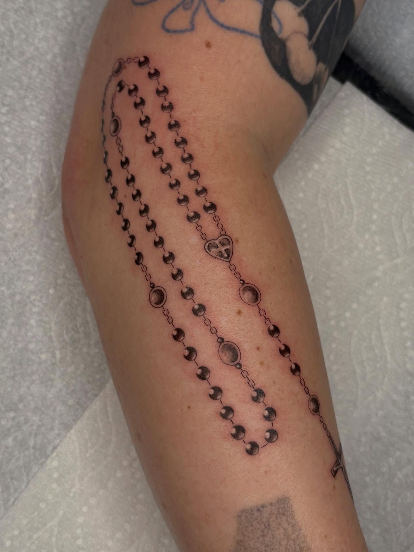 Rosary beads black and grey tattoo on the forearm by Nayoung, San Francisco, California