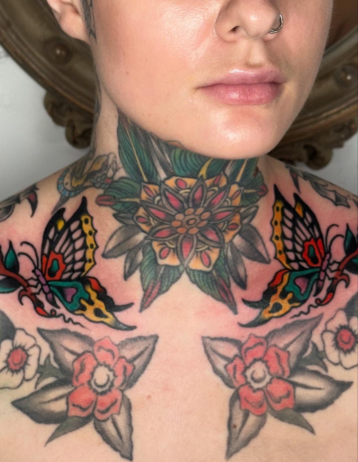 Floral and butterfly American traditional tattoo on the chest by Steve Pearson