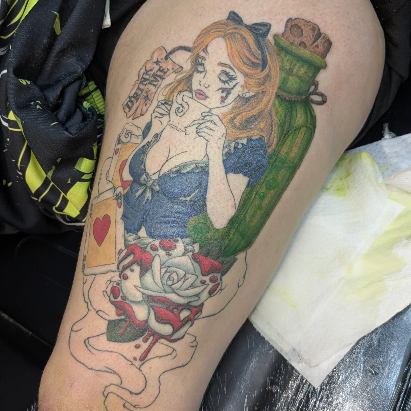 Alice in wonderland American traditional tattoo on the thigh by Jessica Thomas Fleischman, Morganton, North Carolina