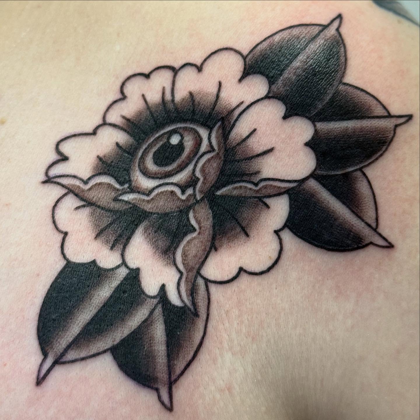 Flower American traditional tattoo on the shoulder by Rigo Vargas