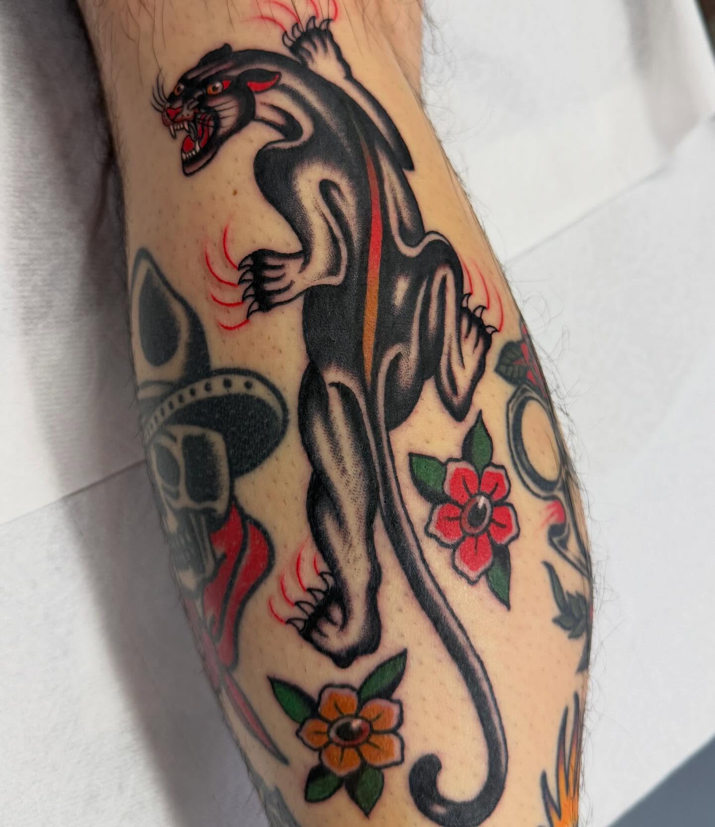Panther and flowers American traditional tattoo on the forearm by David Evans