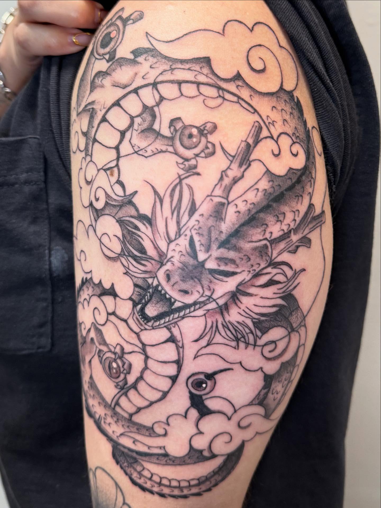 Dragon black and grey tattoo on the forearm by Rigo Vargas