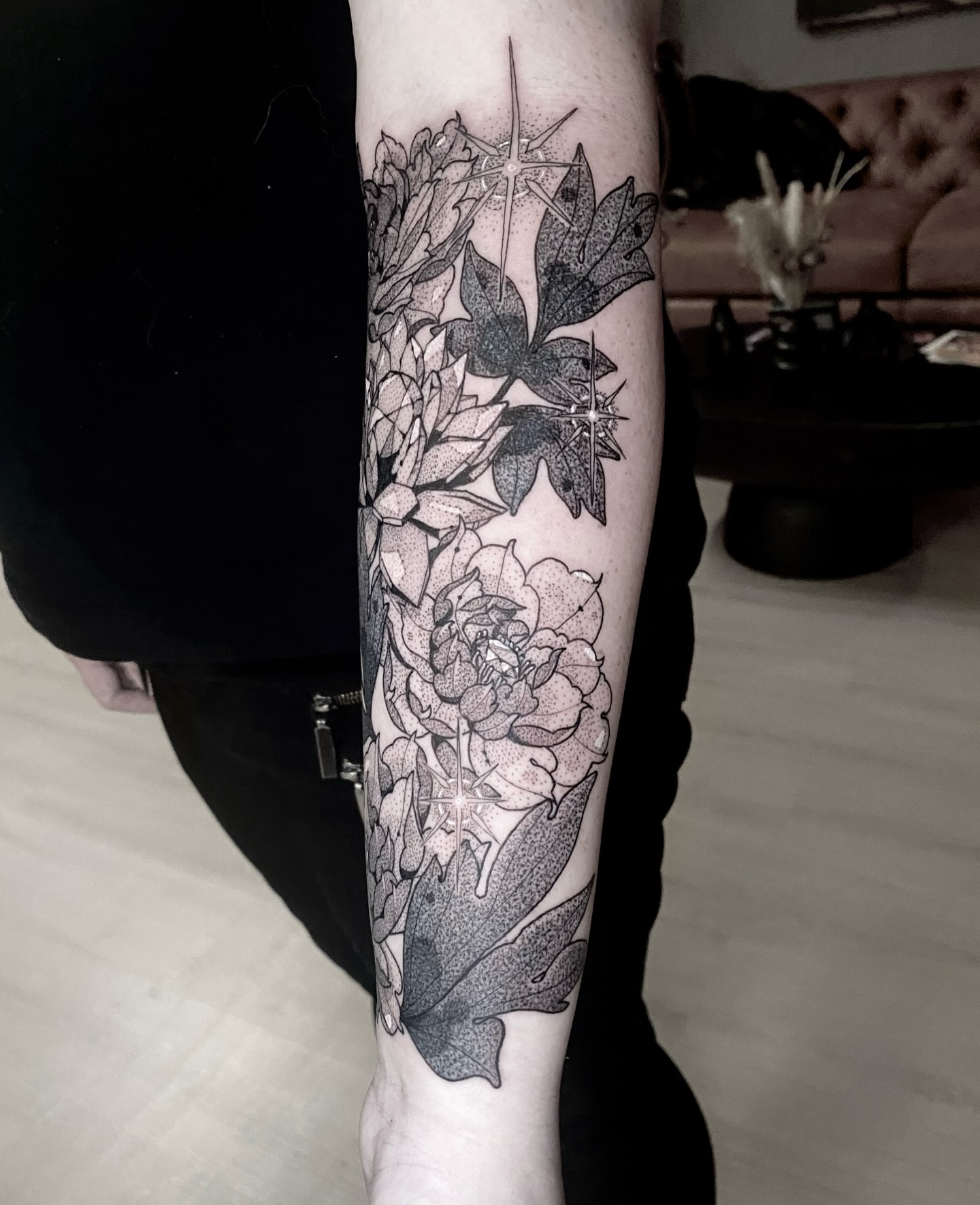 Floral arrangement dotwork tattoo on the forearm by Rowan Starr