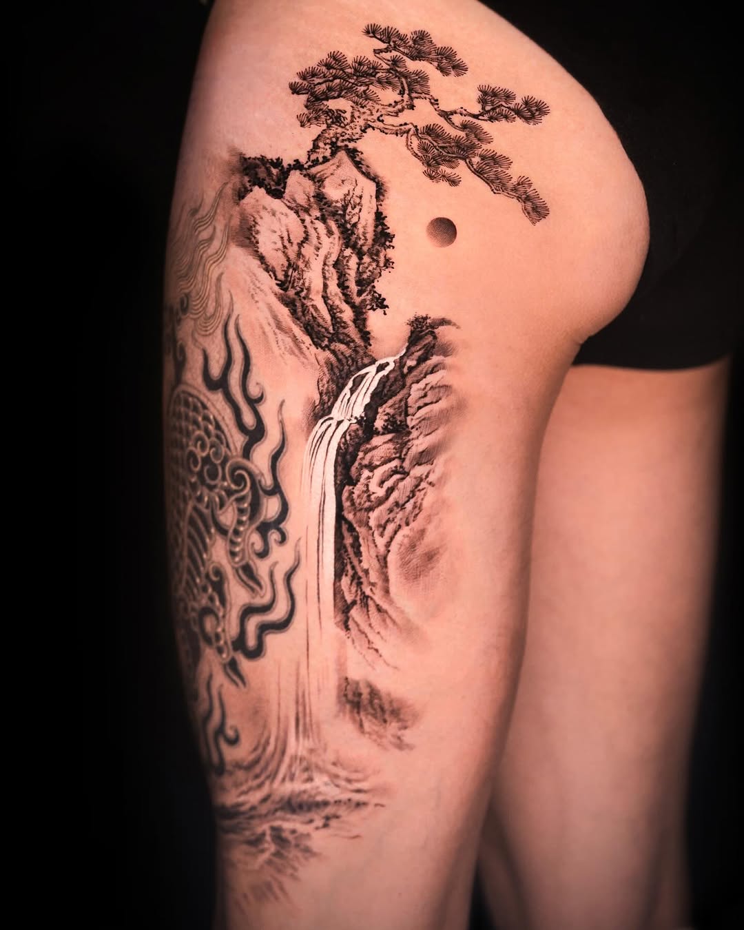 Dragon, waterfall, and pine tree landscape Japanese tattoo on the upper arm by Rizn