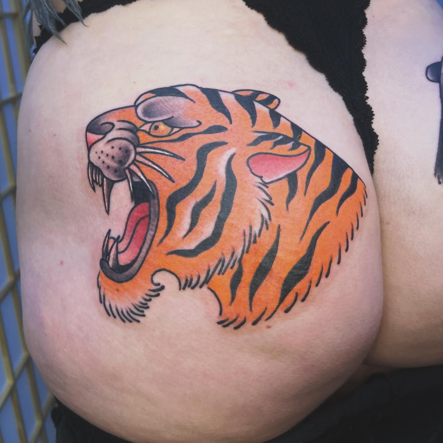 Tiger American traditional tattoo on the shoulder by Sarah Foltz