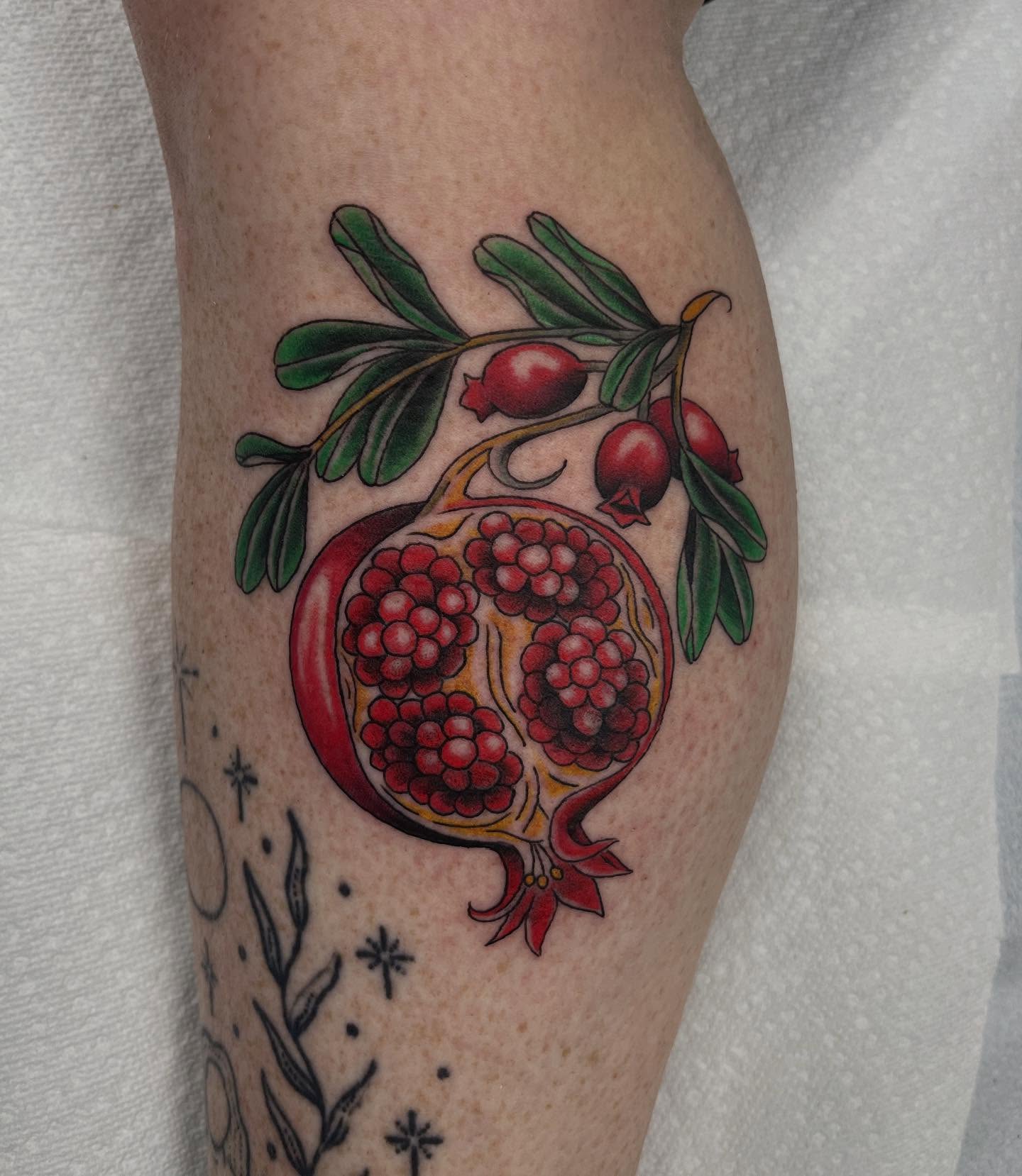 Pomegranate realism tattoo on the forearm by Brian Mcfadden