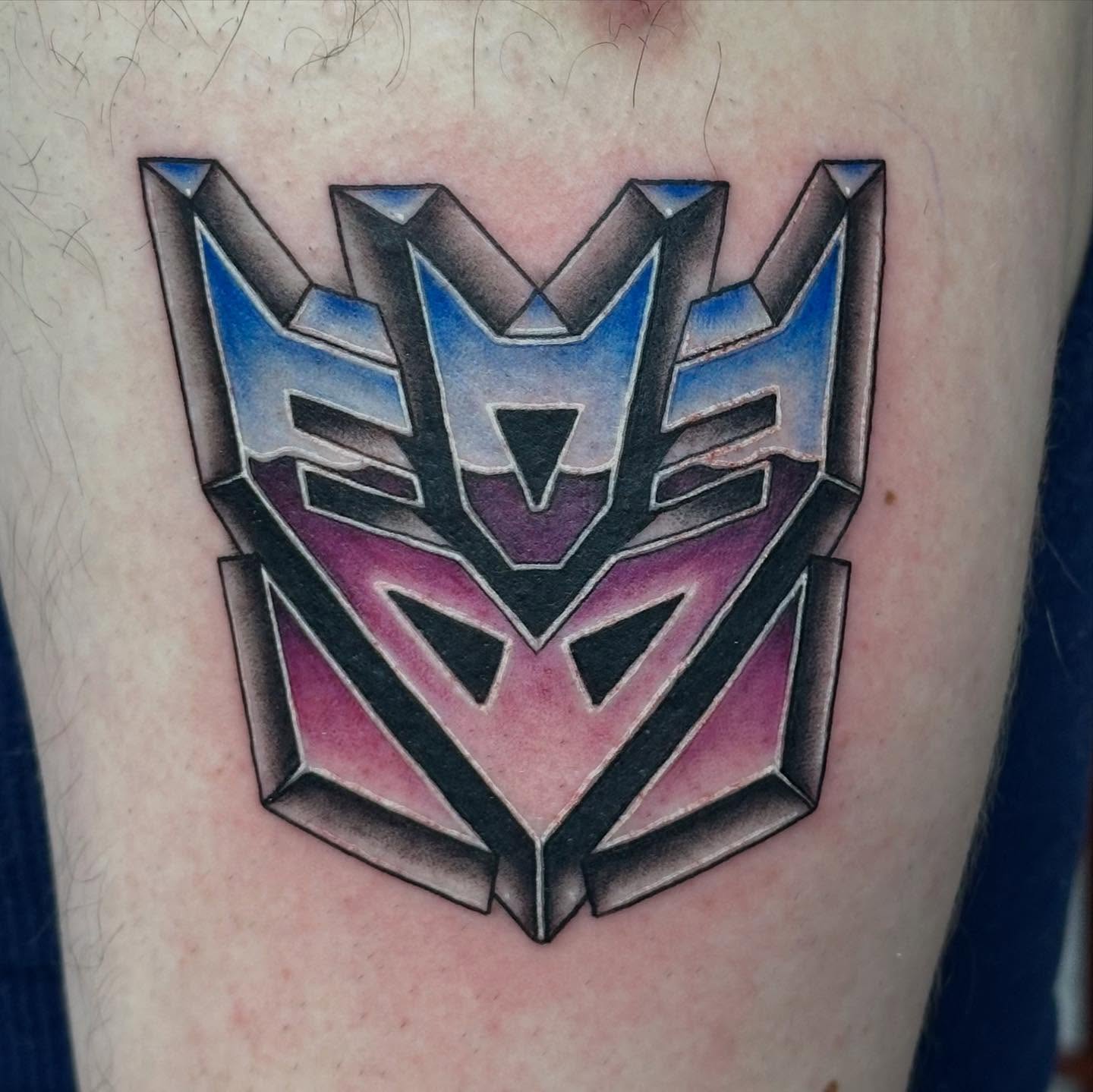 Decepticon symbol geometric tattoo on the forearm by Olivia Norbert