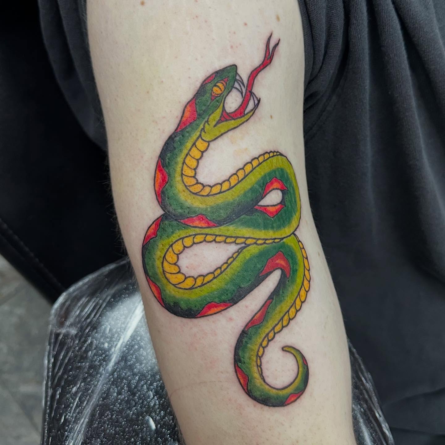 Snake American traditional tattoo on the forearm by Olivia Norbert
