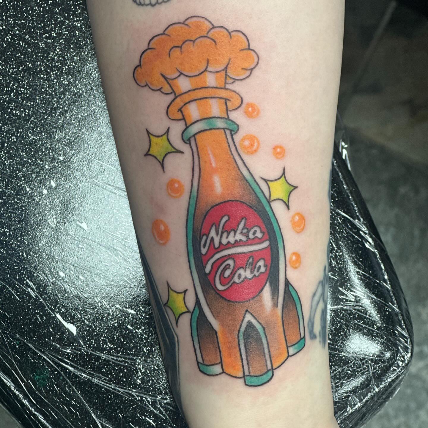 Nuka cola bottle American traditional tattoo on the forearm by Olivia Norbert
