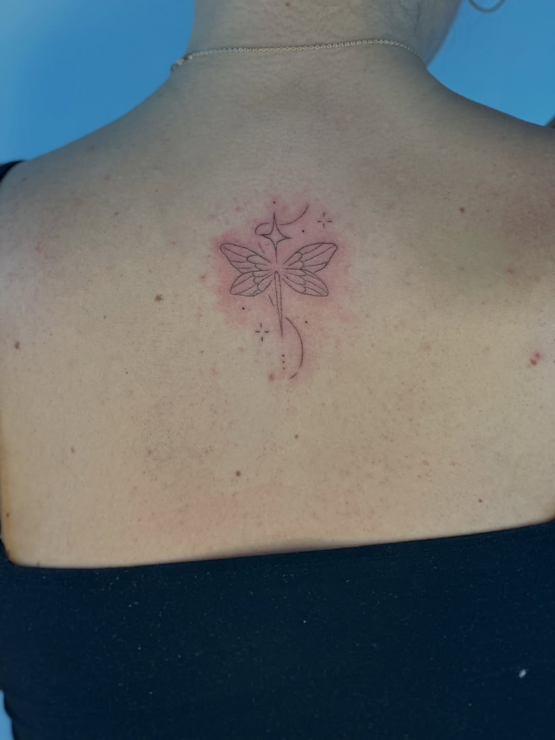 Dragonfly with stars fine line tattoo on the back by Cherry🥀