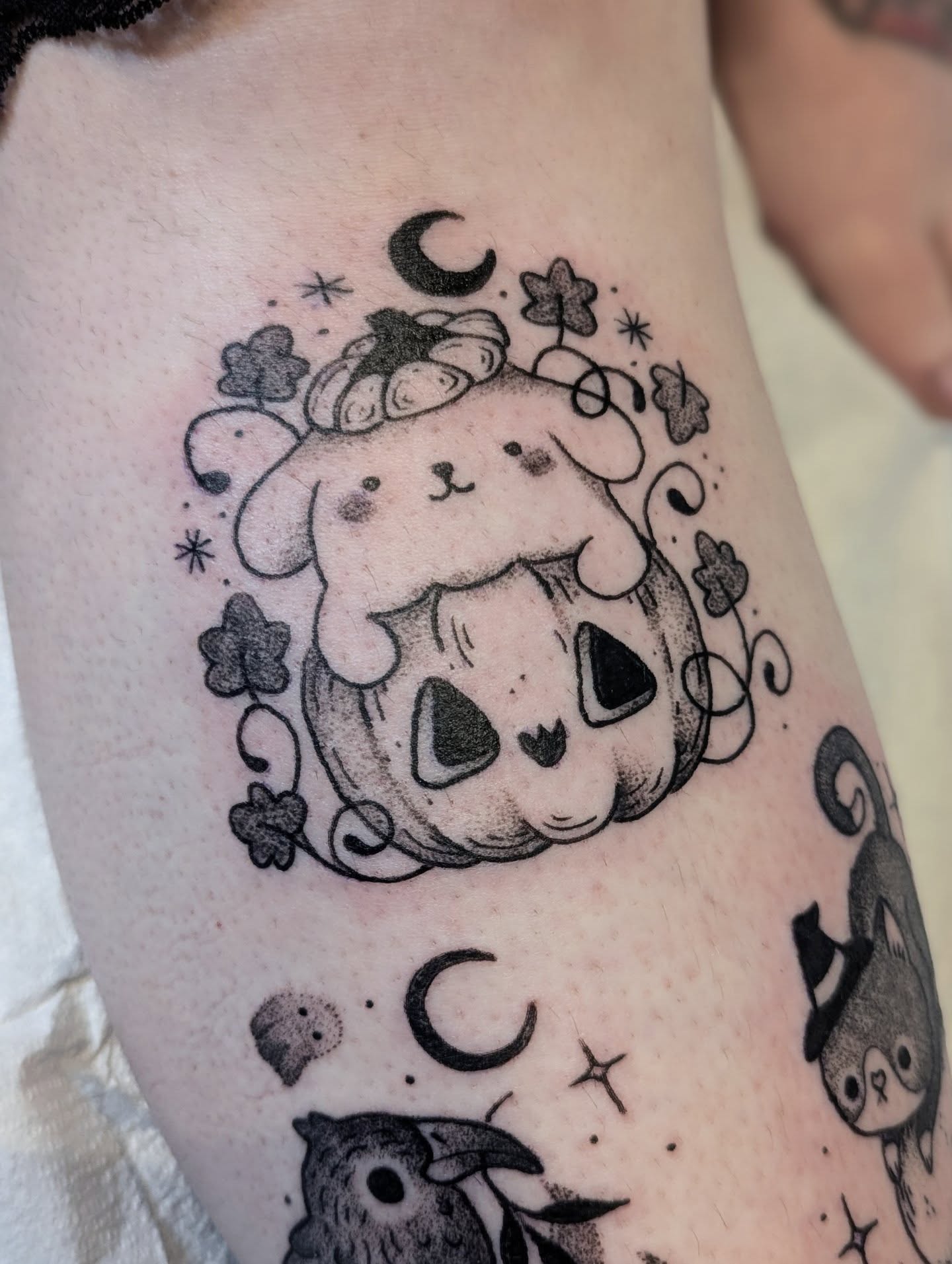 Pumpkin and cat black and grey tattoo on the forearm by Dani Harkey