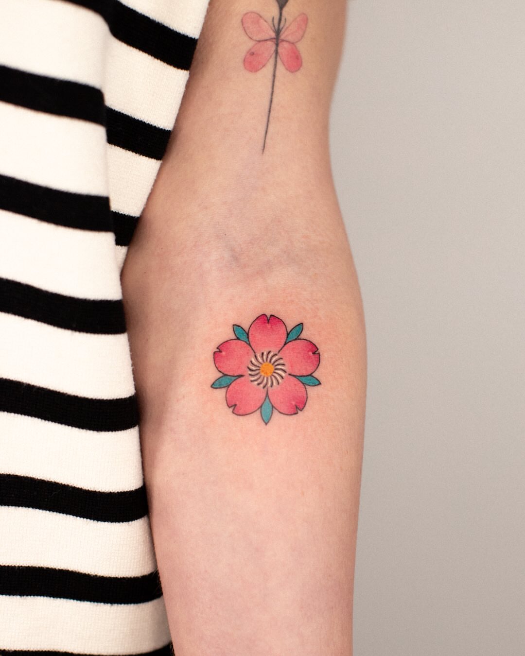 Cherry blossom watercolor tattoo on the forearm by 홍대타투